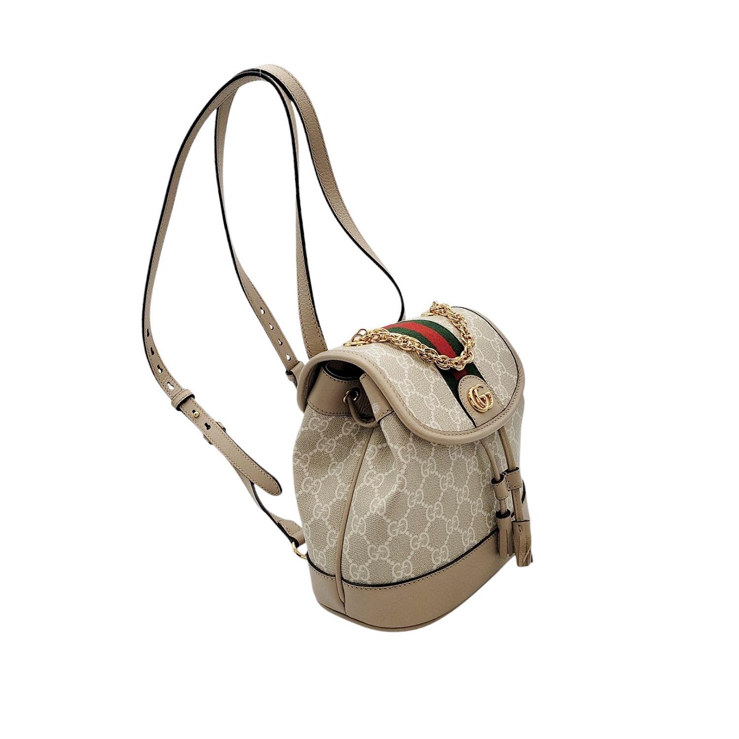 Elevate your style with the Gucci Ophidia Mini GG Supreme Canvas & Leather Backpack. Handcrafted in Italy, it features the iconic GG Supreme coated canvas, leather trimming, and luxurious gold-tone hardware. The magnetic snap and leather cinch cord