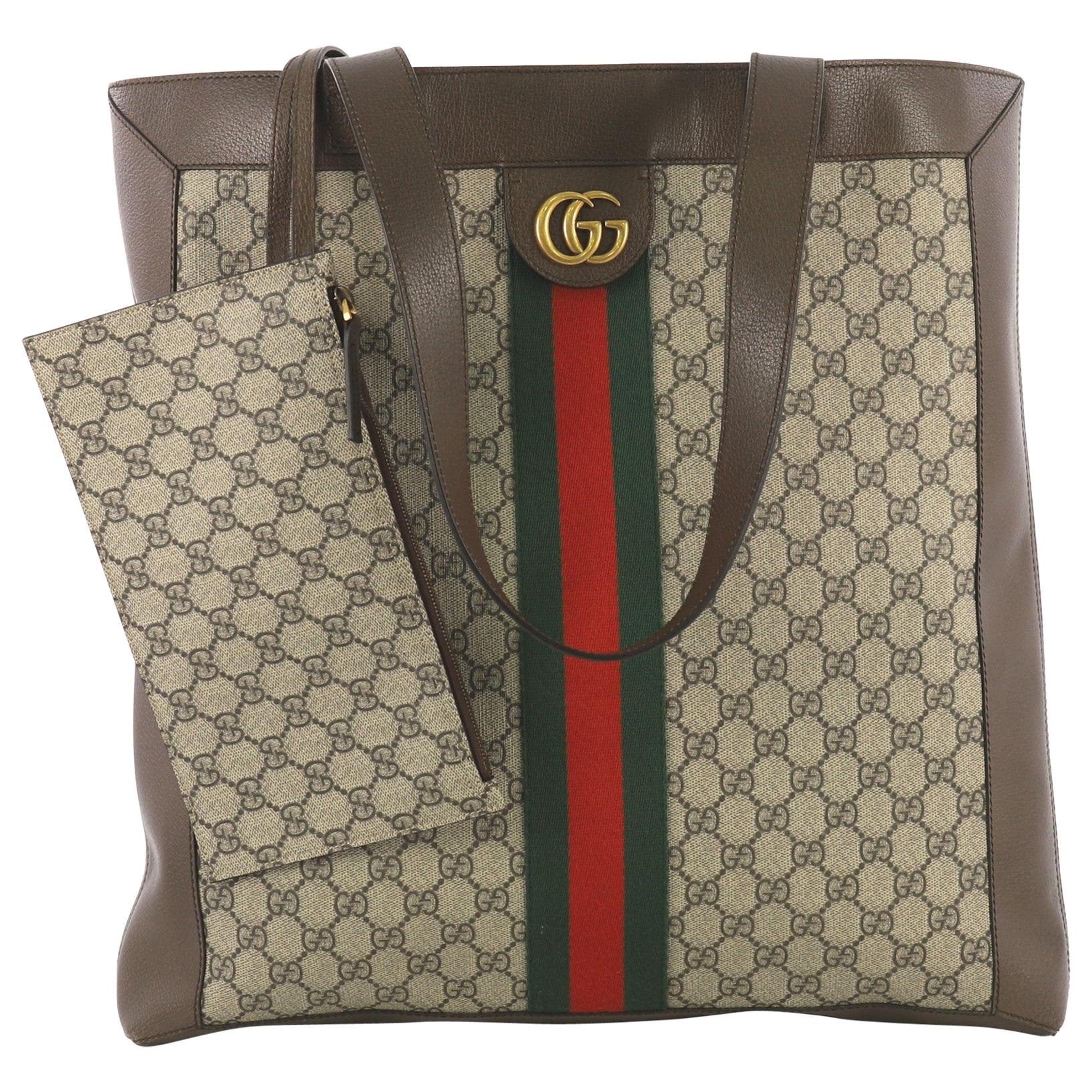 This Gucci Ophidia Soft Open Tote GG Coated Canvas Large, crafted in brown GG coated canvas, features dual leather shoulder straps, Gucci web design, and aged gold-tone hardware. It opens to a nude microfiber interior. 

Estimated Retail Price: