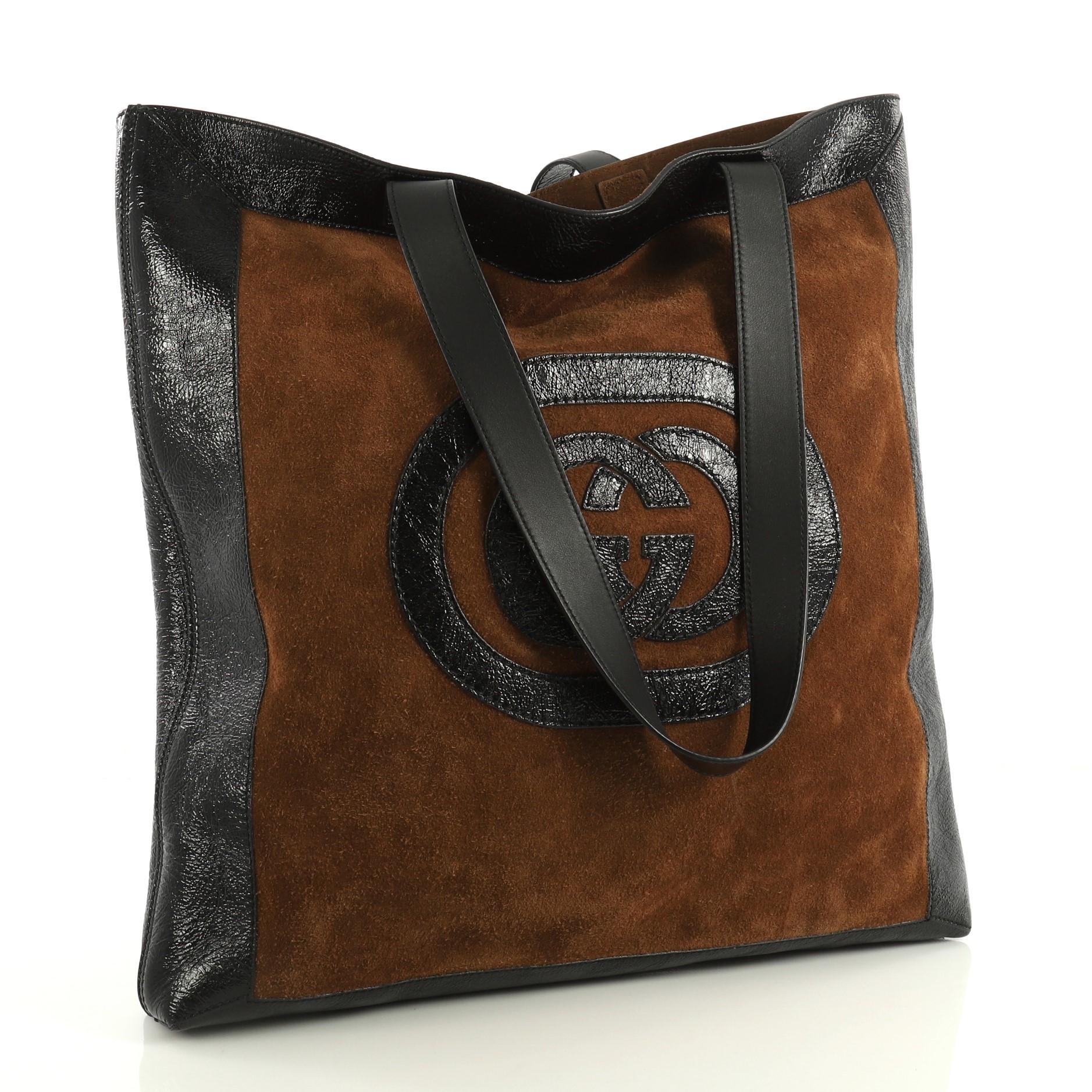 This Gucci Ophidia Soft Open Tote Suede Large, crafted in brown suede, features dual flat leather handles, leather trim, and aged gold-tone hardware. It opens to a brown suede interior. 

Estimated Retail Price: $2,290
Condition: Very good. Moderate