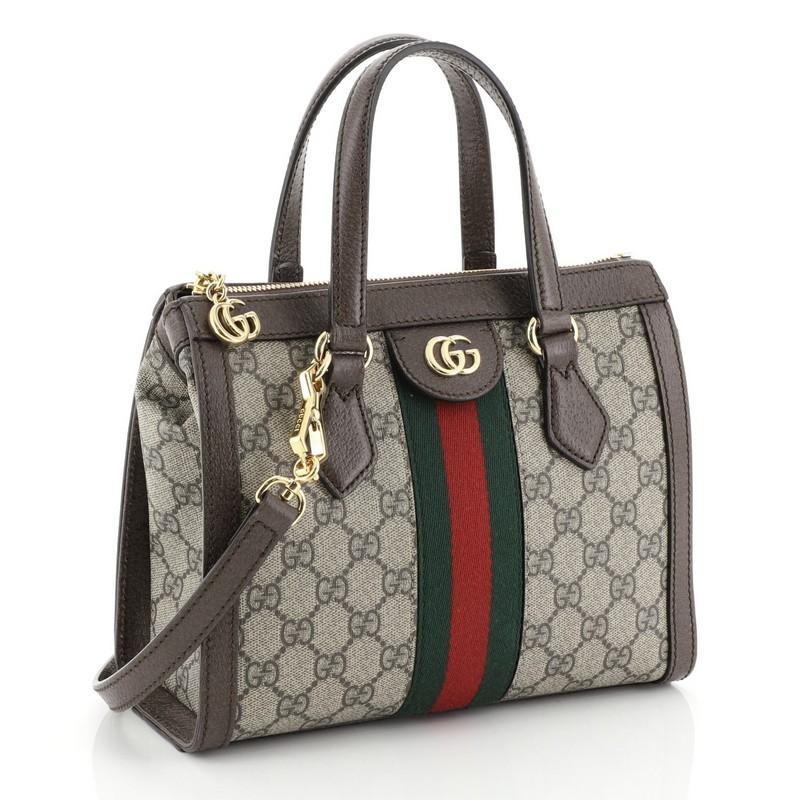 This Gucci Ophidia Top Handle Bag GG Coated Canvas Small, crafted in brown GG coated canvas, features dual leather handles, Gucci web design, leather trim, and gold-tone hardware. Its zip closure opens to a neutral microfiber interior with slip