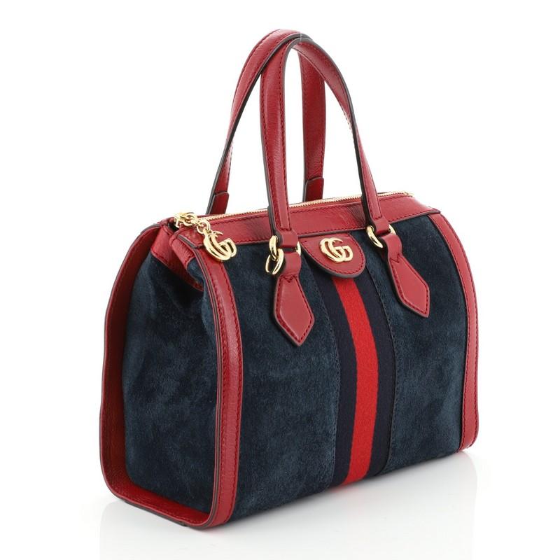This Gucci Ophidia Top Handle Bag Suede Small, crafted in blue suede, features dual flat handles, web strap detailing, and gold-tone hardware. Its zip closure opens to a neutral microfiber interior with zip and slip pockets. 

Estimated Retail