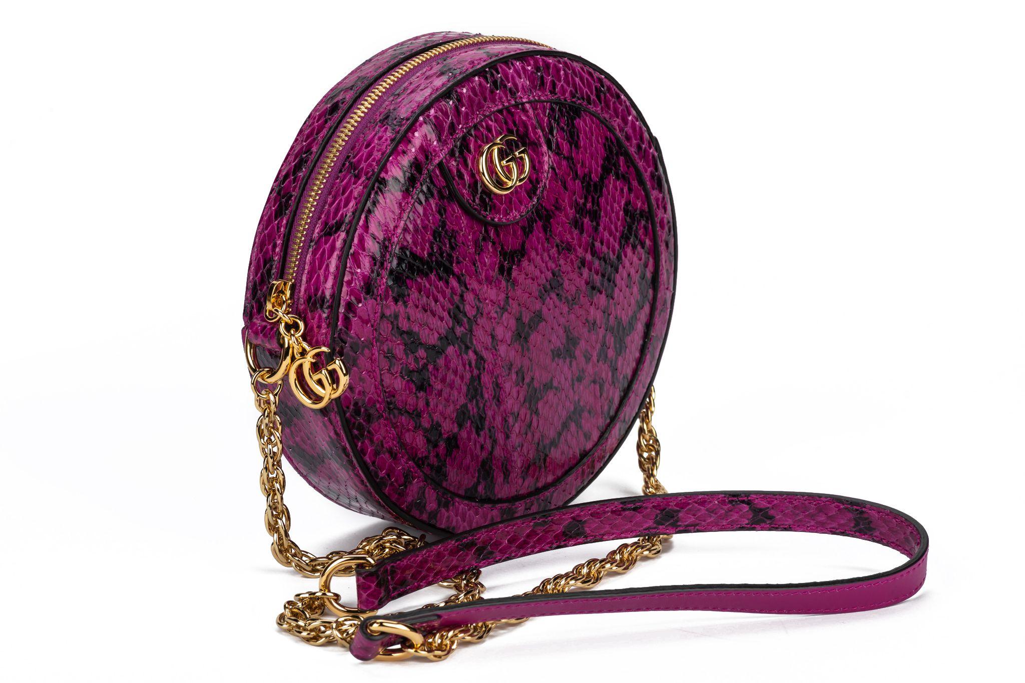 GUCCI Ophidia watersnake Mini Round Shoulder Bag in the color purple. The shoulder strap measures 23 inches and the interior is made of beige leather. The bag comes with the original box and dustcover. New in unworn condition. 