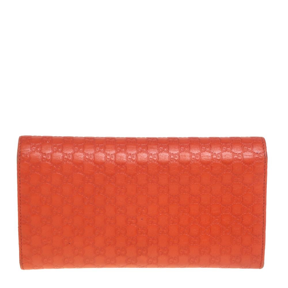 Made from the signature Microguccissima leather in orange, this continental wallet from Gucci is beautified with the brand detailing on the front flap. The flap opens to a sleek interior featuring multiple compartments and card slots.

