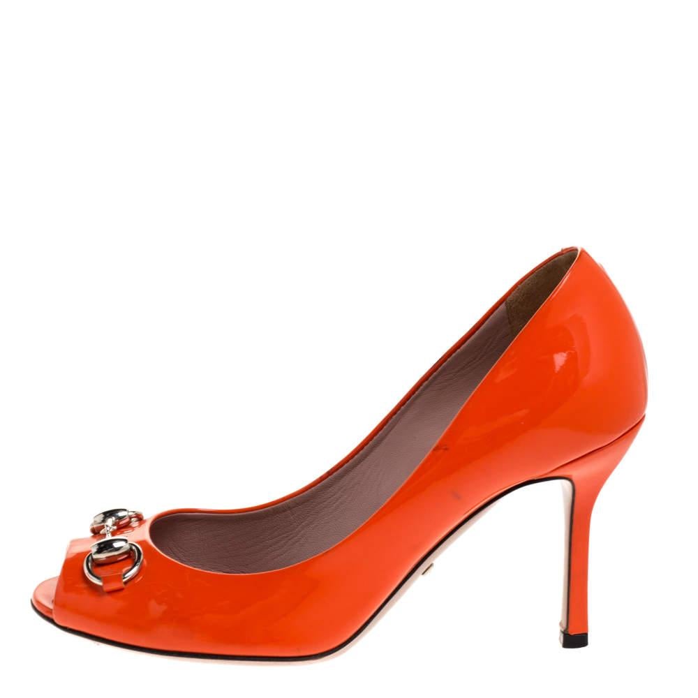 Finesse and poise will all come naturally to you when you step out in this pair of pumps from Gucci. Crafted from orange hued patent leather  the peep toe pumps have been styled with neat stitching  8.5 cm heels  and the iconic Horsebit detail on
