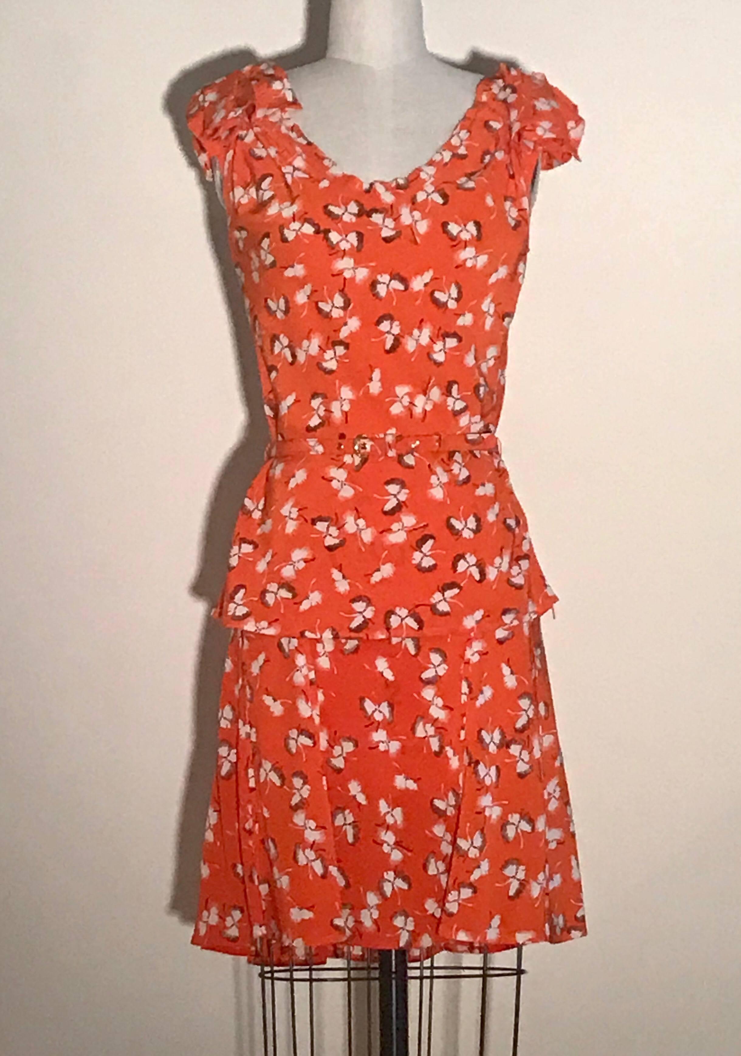 Gucci orange silk floral print three piece set. Includes sleeveless blouse with drape detail at shoulders, skinny belt, and skirt with seam detail throughout. Top has side zip, skirt has back zip. Two string loops at side for belt. 

So versatile--