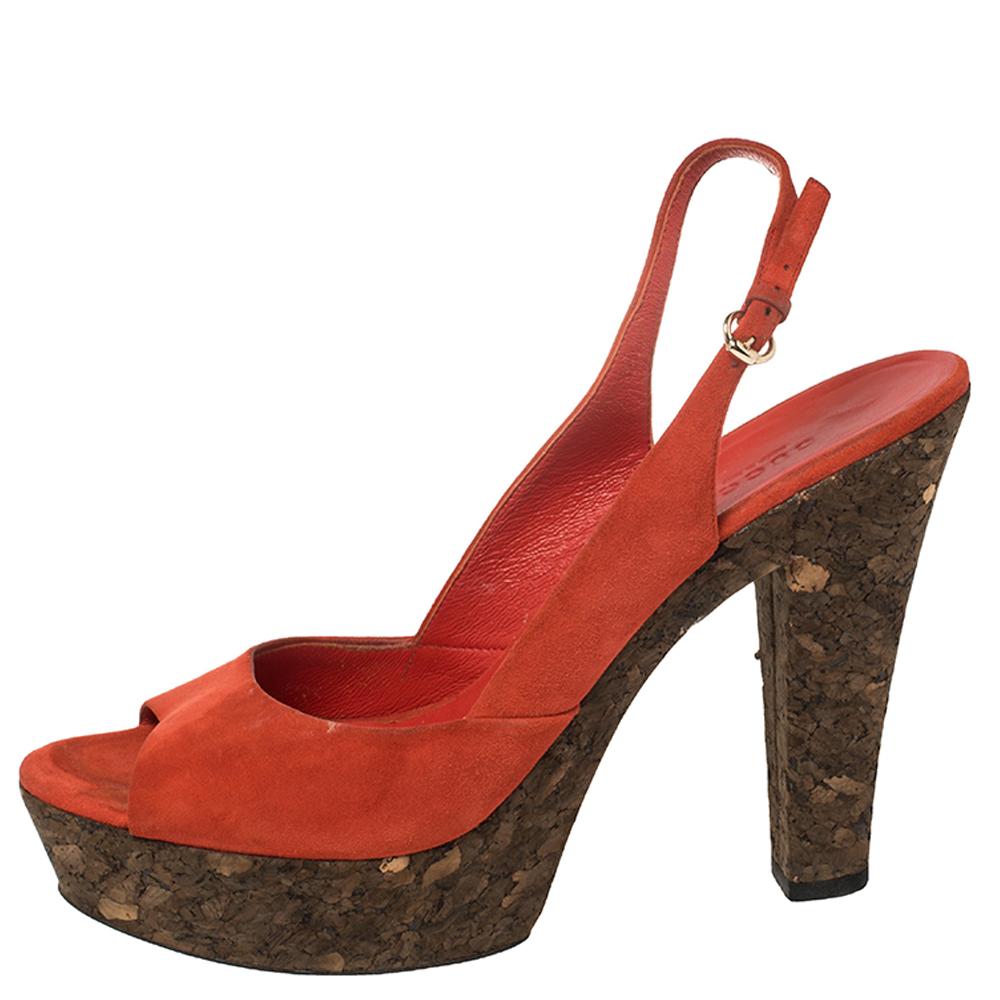 Made from luxurious suede, these sandals are a splendid example of luxurious footwear. They feature peep-toes, slingbacks, platforms, and 13 cm cork heels. A pair of stunning orange Gucci sandals like this one is a closet must-have.

Includes: