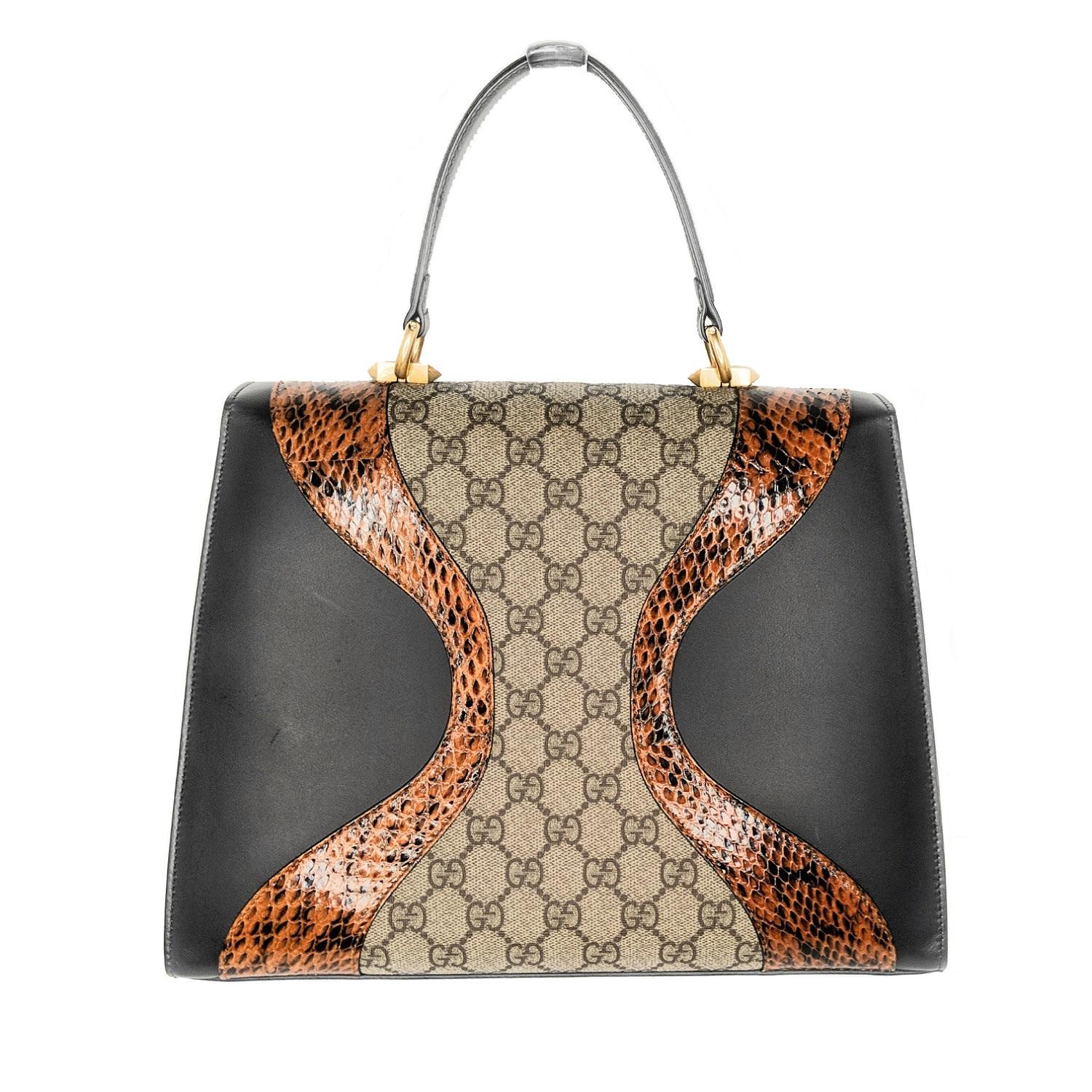 Genuine snakeskin waves beautifully set off the GG Supreme canvas and ebony-hued leather on a stunning top-handle bag featuring an enameled tiger head with red Swarovski eyes at the clasp and an optional shoulder strap. Estimated retail price is