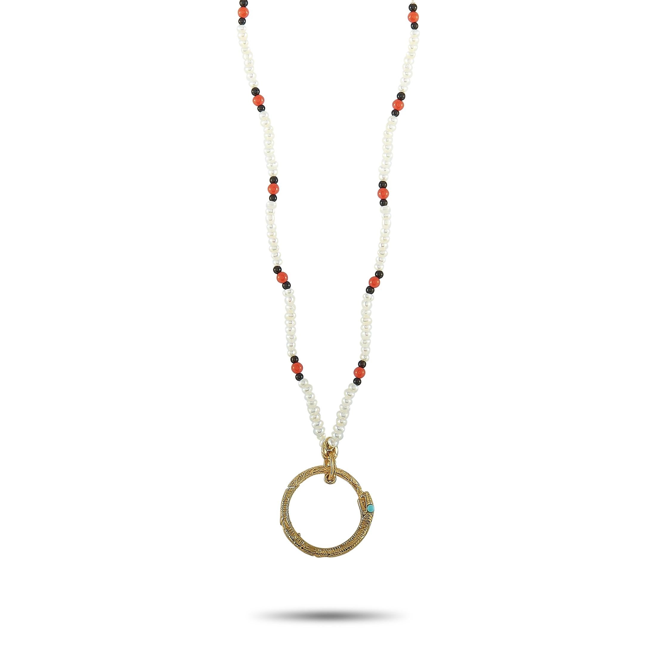 The Gucci “Ouroboros” necklace is made of 18K yellow gold and embellished with pearls and turquoise, coral, and onyx stones. The necklace weighs 7 grams and measures 22” in length, boasting a 1” by 0.75” pendant.
 
 This jewelry piece is offered in
