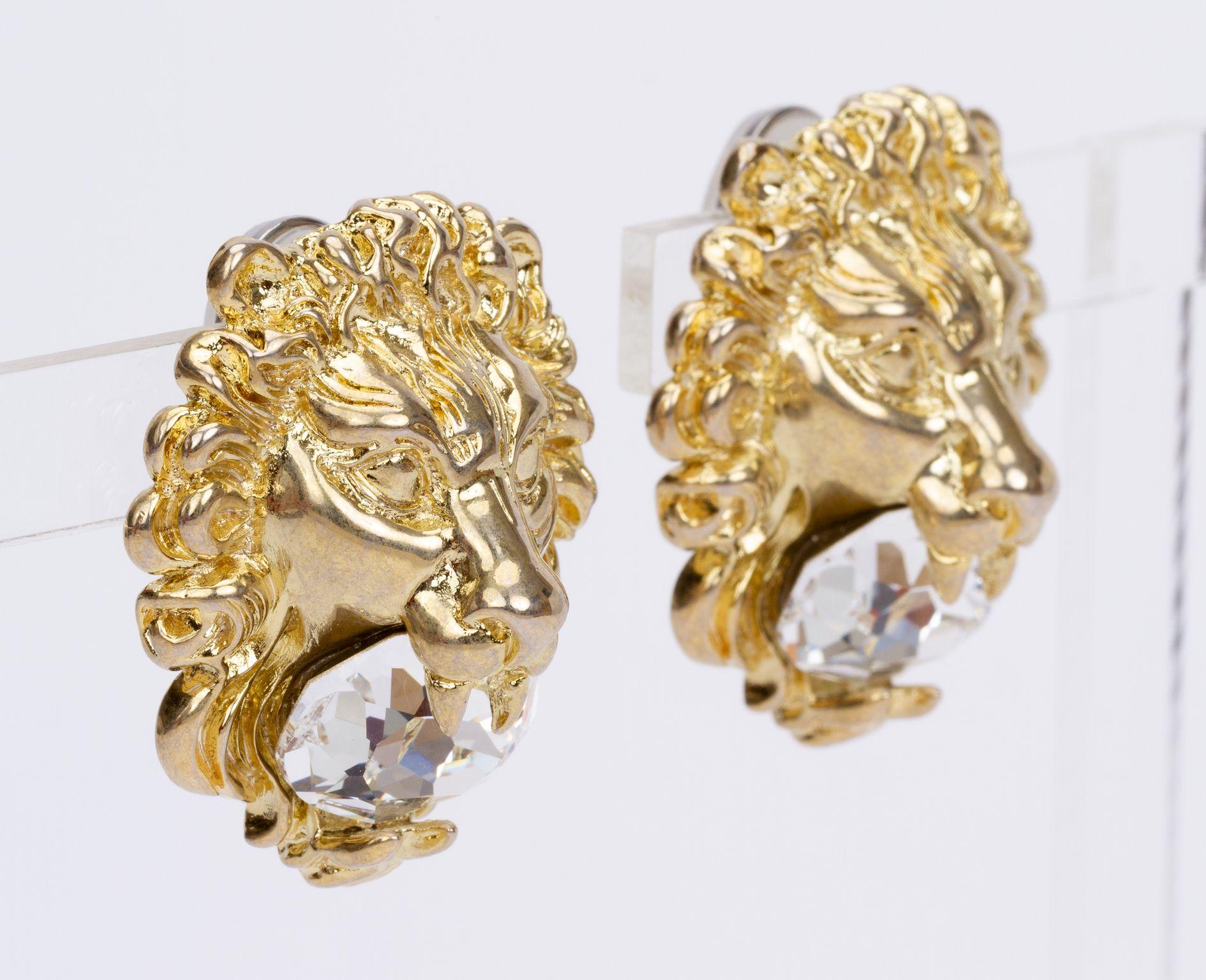 Gucci earrings in form of a lion who holds a crystal in it's mouth. They're clip on and brand new. They come with the original box and dust cover.
