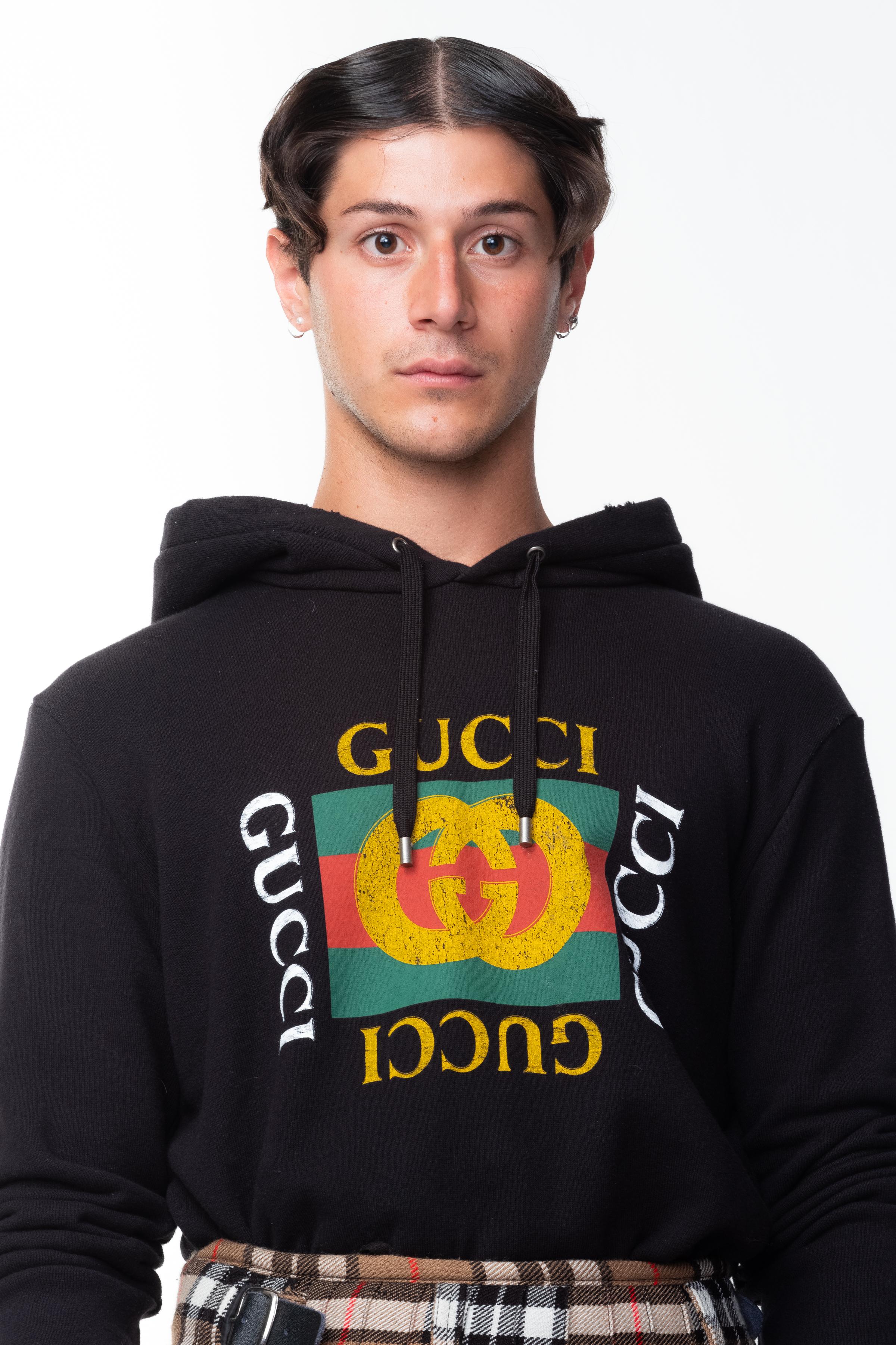 Gucci Oversize Logo Sweatshirt, vintage style oversized sweatshirt with washed fabric detail and worn out look, vintage graphic logo on the front. 

COLOR: Black with gold logo, white, green and red accents. 
MATERIAL: 100% cotton.
ITEM CODE: