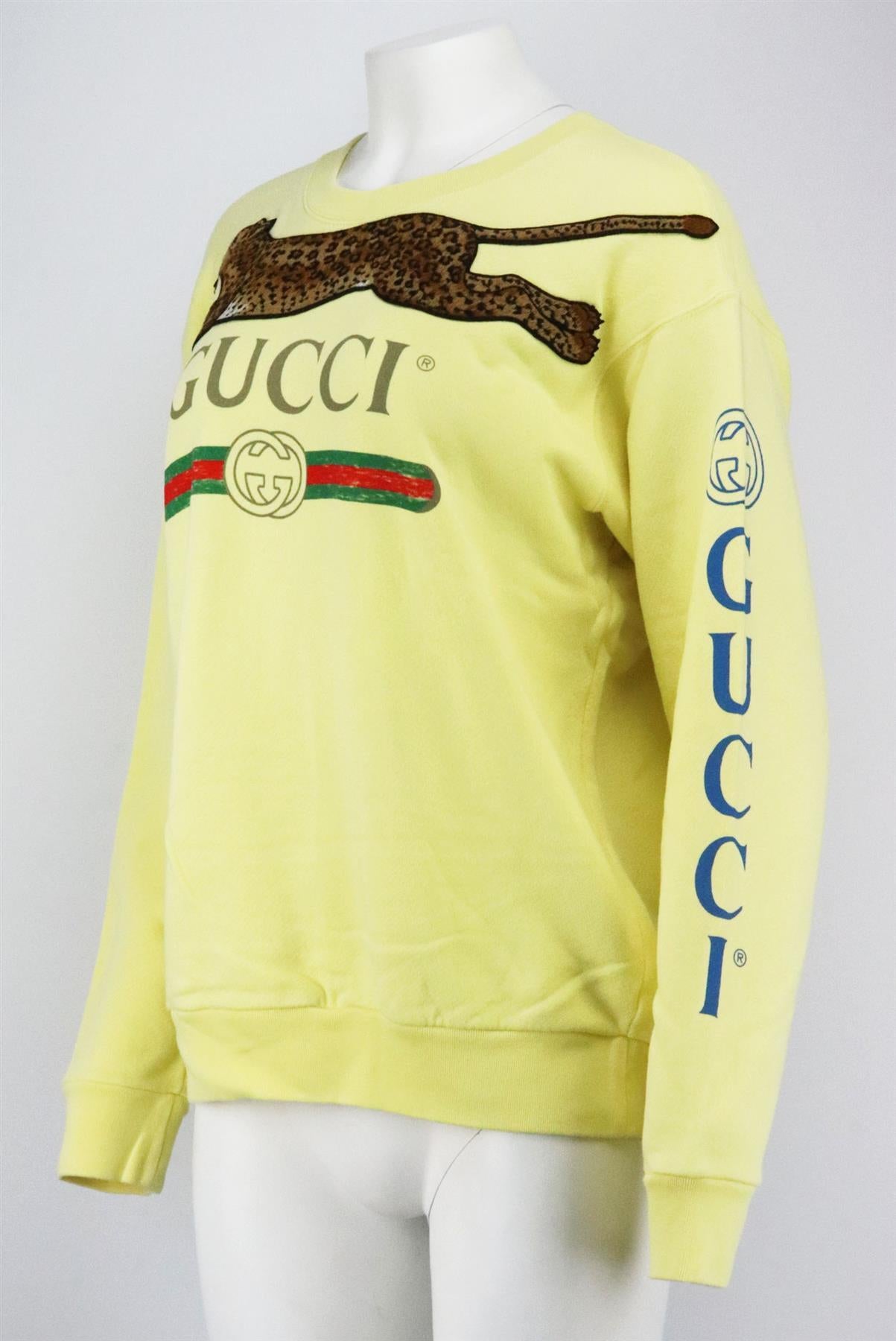 This sweatshirt by Gucci is made in a yellow cotton-terry style and cut for an oversized fit and adorned with an appliquéd leopard motif and the brand’s iconic moniker on the front and down the arm. Yellow cotton. Slips on. 100% Cotton. Size: Small