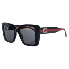 Gucci, oversized sunglasses with webbing