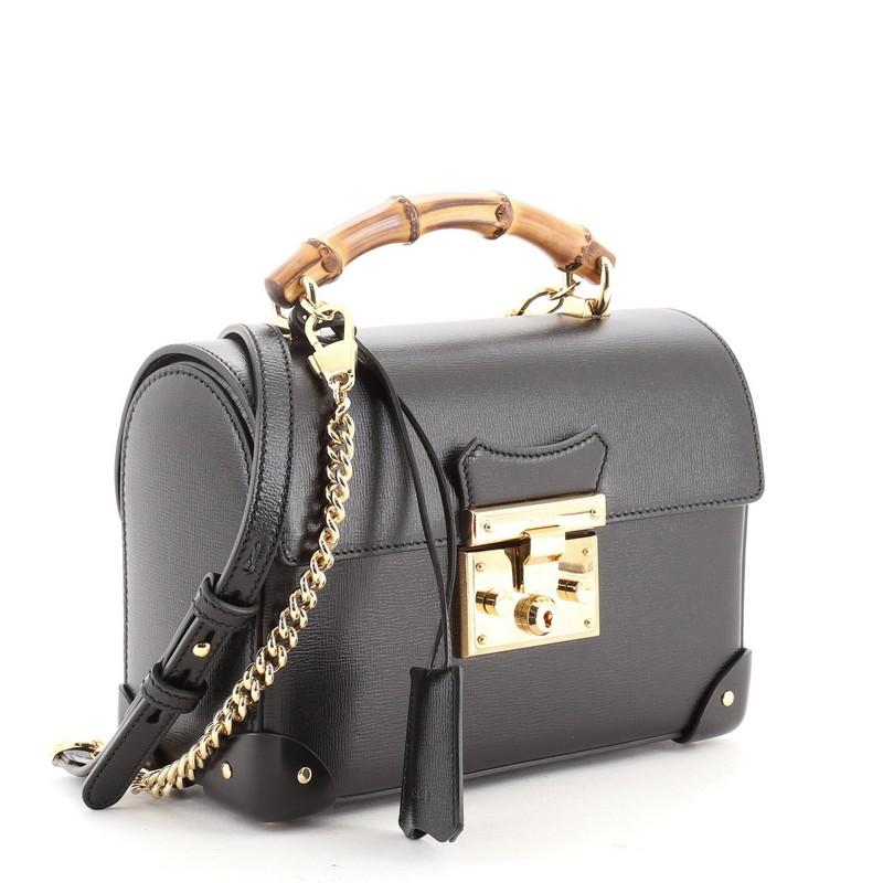 A UNIQUE BLACK LEATHER BAMBOO BAG WITH 18K YELLOW GOLD HANDLE