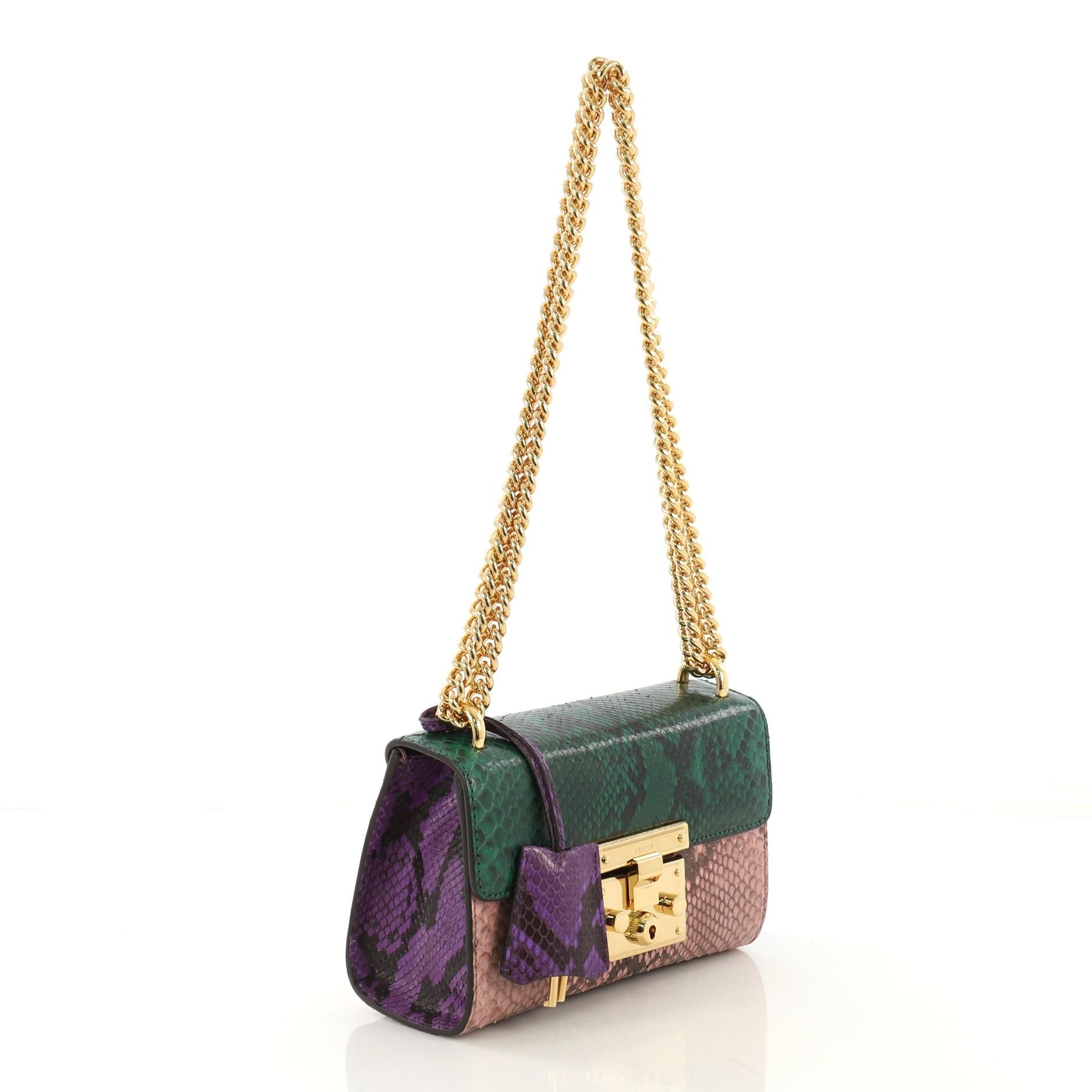 This Gucci Padlock Shoulder Bag Python Small, crafted in genuine multicolor python, features chain link strap, exterior back card pocket, and gold-tone hardware. Its padlock push-lock closure opens to a beige microfiber interior with slip pocket.