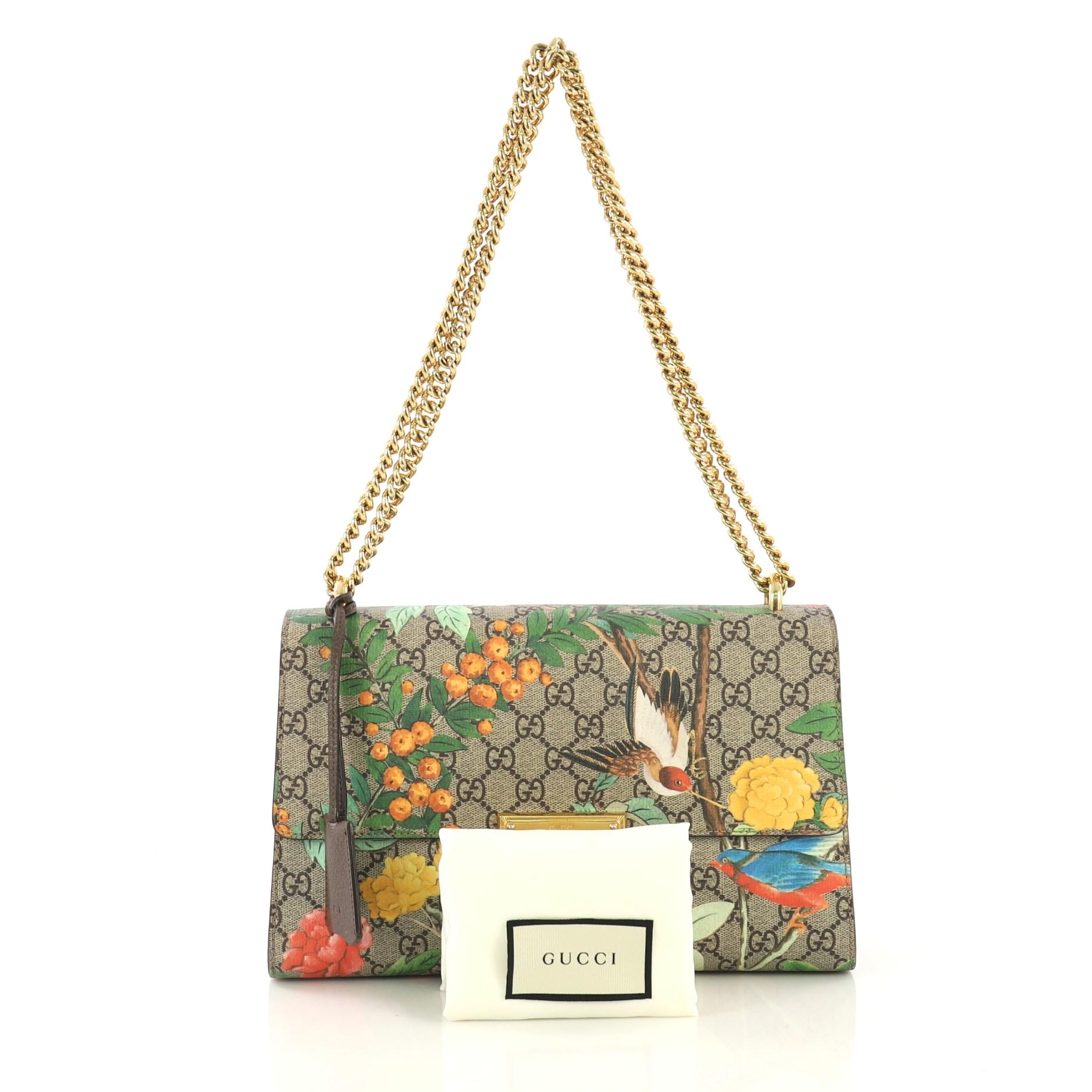  This Gucci Padlock Shoulder Bag Tian Print GG Coated Canvas Medium, crafted in Tian print light brown GG coated canvas, features chain-link strap, exterior back pocket, and gold-tone hardware. Its push-lock closure opens to a brown microfiber
