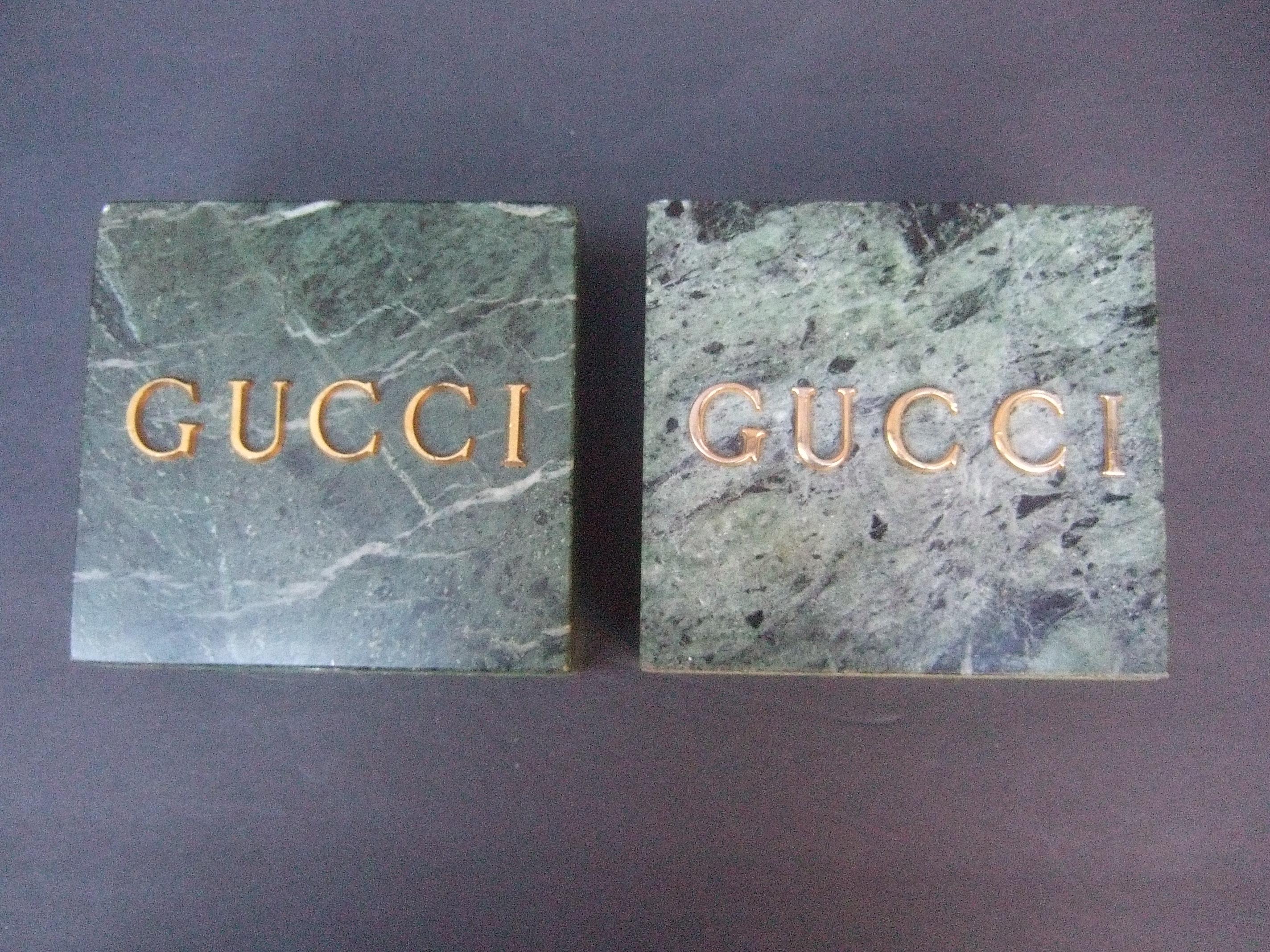 Gucci pair of muted green marble stone bookends / decorative objects c 1970s
The sleek pair of green marble blocks were originally display fixtures at Gucci boutiques in the 1970s and 1980s

The pair of Gucci inscribed marble blocks could be