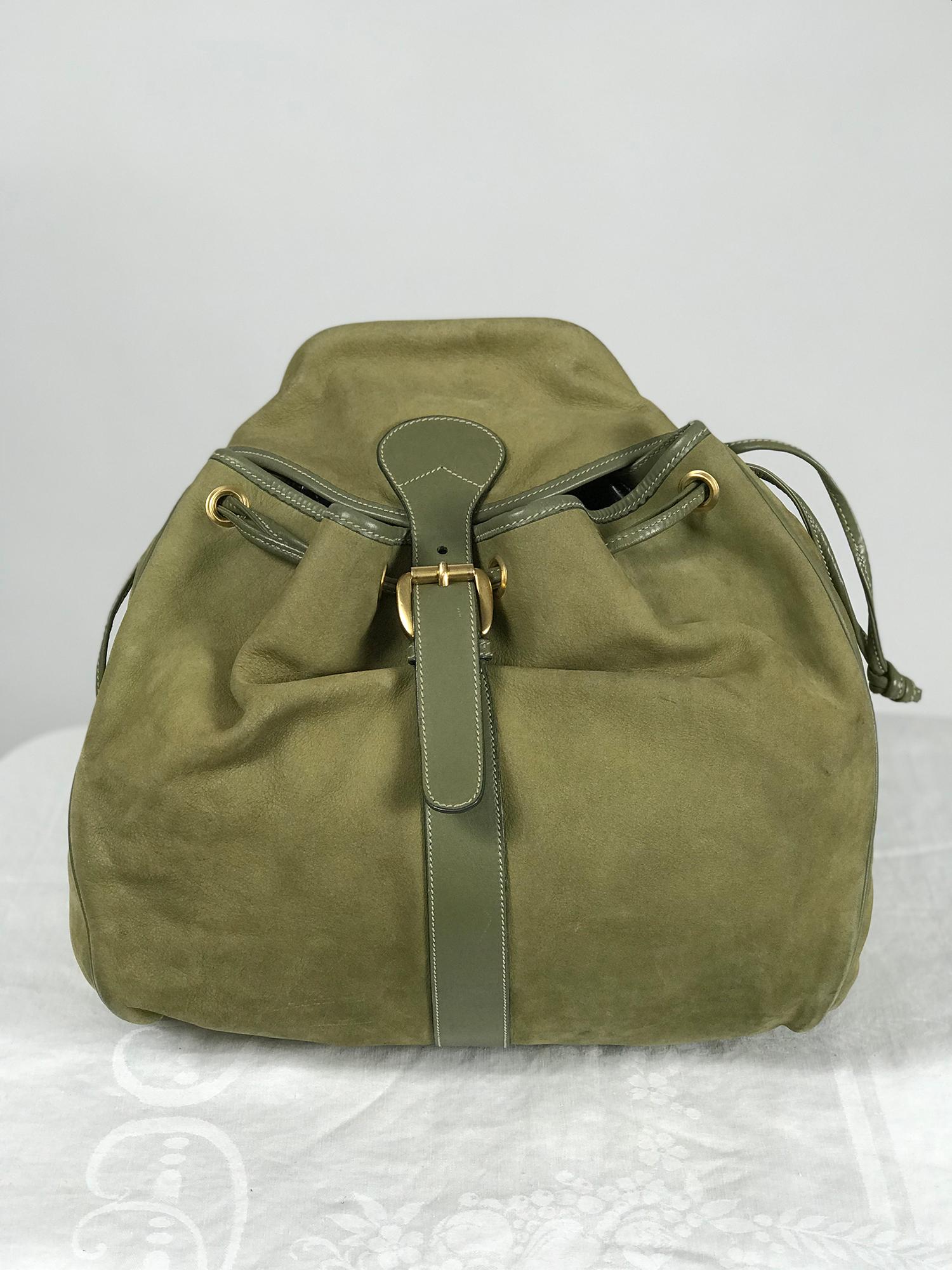 Gucci pale moss green leather and suede backpack. This beautiful piece is perfect for traveling or work, it's roomy and well made. The colour is very unusual. Gold metal hardware, the rivets have double G logos, the front closes with a gold buckle.