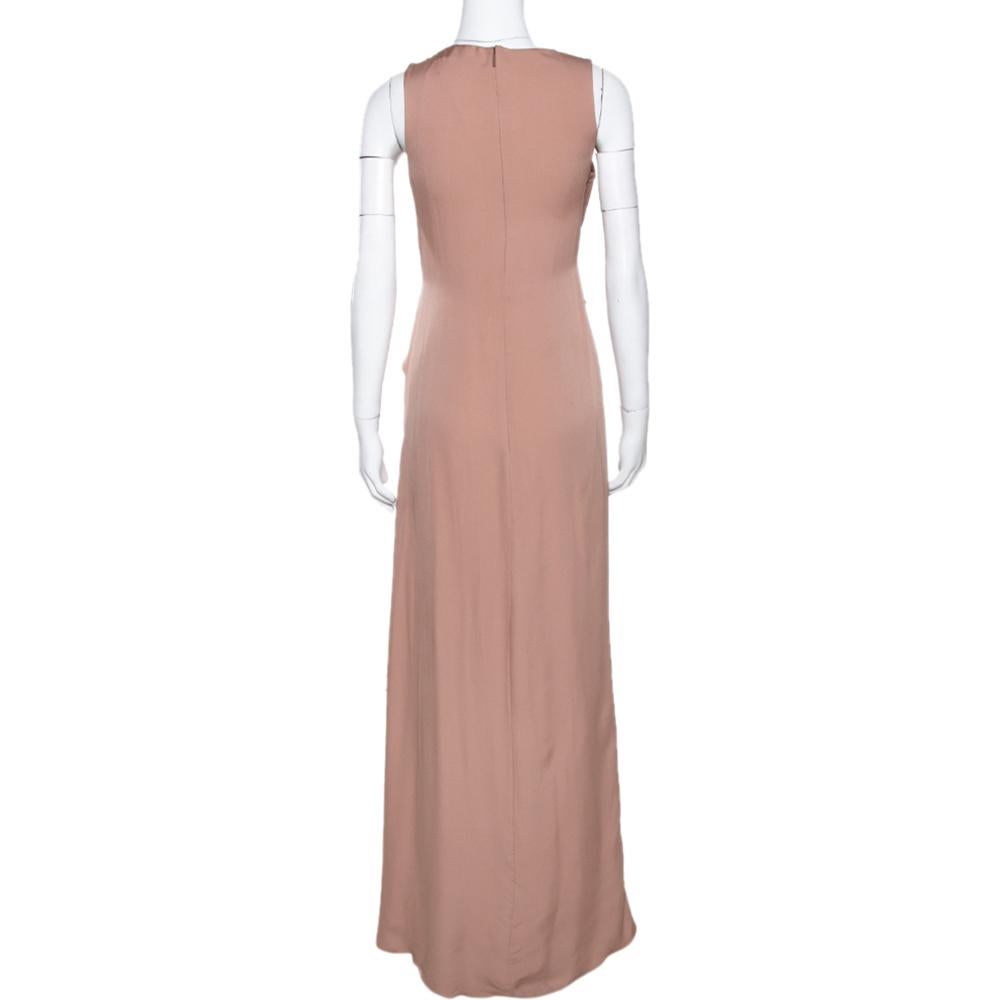 This lovely Gucci gown embodies elegance and femininity. Perfect for special occasions and evening wear, this creation is an absolute must-have. It has been cut from pure silk and comes in a beautiful shade of pale pink. This sleeveless creation has