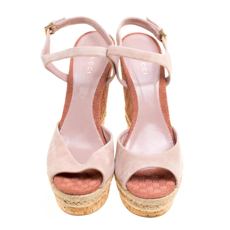 If you are looking for something elegant with a subtle touch of statement style, the Hollie wedges sandals by Gucci would do the trick. In pale pink suede, these sandals, come with GG printed wedges with espadrille detailing on the midsole and cork