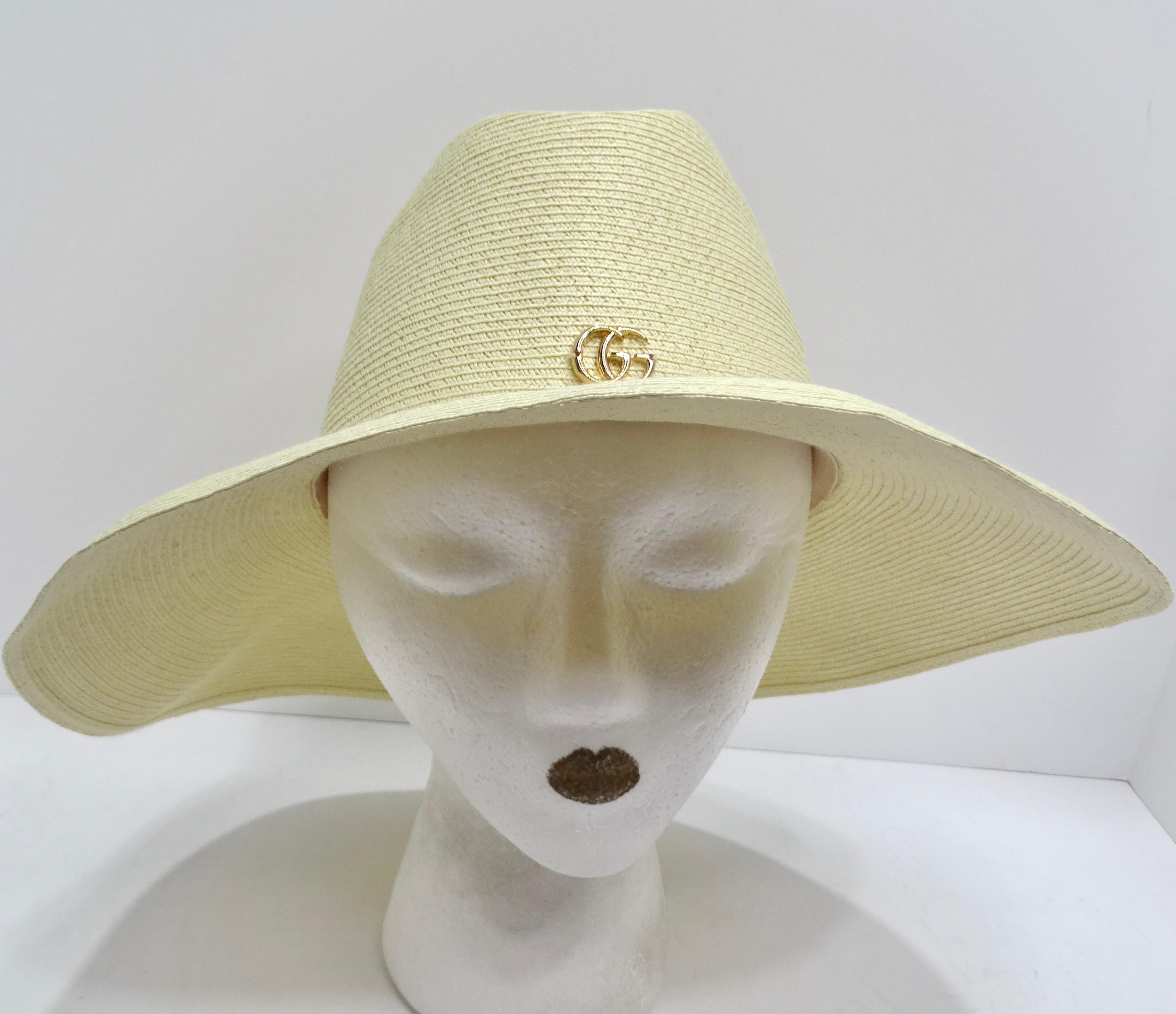 Introducing the Gucci Papier Wide Brim Hat – the epitome of chic and luxury for those sunny days. Crafted from ivory raffia straw and adorned with a gleaming gold Gucci logo, this hat is more than just sun protection; it's a fashion statement. The