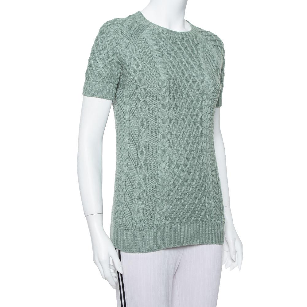 Gucci brings you this lovely sweater to make you look very stylish and win compliments from one and all! The pastel green creation is made of a wool-blend and features a relaxed silhouette. It flaunts a round neckline, cable knit and short sleeves.