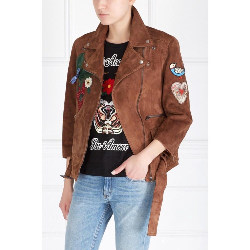 This leather bomber jacket is embellished with embroidered flower appliques, a large bee, a signature detail for the brand. 
Across the back reads the phrase 