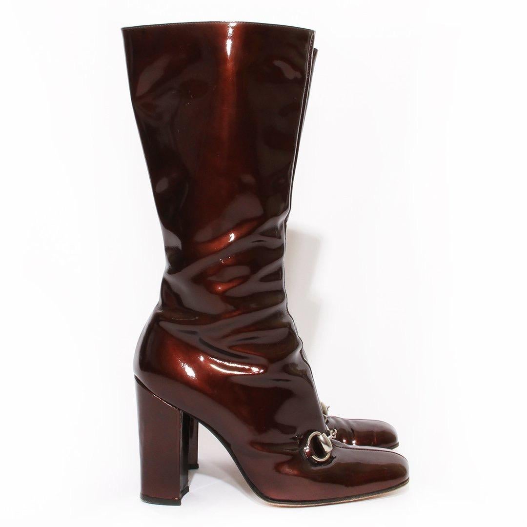 Patent boot by Tom Ford for Gucci 
Fall/Winter 1995 RTW
Wine color 
Horsebit front detail 
Zip side closure 
Block heel 
Round toe 
Silver-tone hardware
Made in Italy
Condition: Great, wear on leather, scuffing and marks on leather. Scuffing and