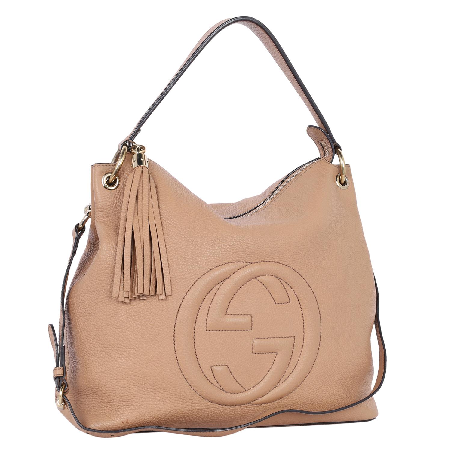 Authentic, pre-owned Gucci GG Soho tan pebbled leather hobo shoulder bag. This classic Gucci  leather cross body bag makes a perfect everyday bag. Features GG logo on the front, zipper top closure with fringe pull tab, dual shoulder straps to wear