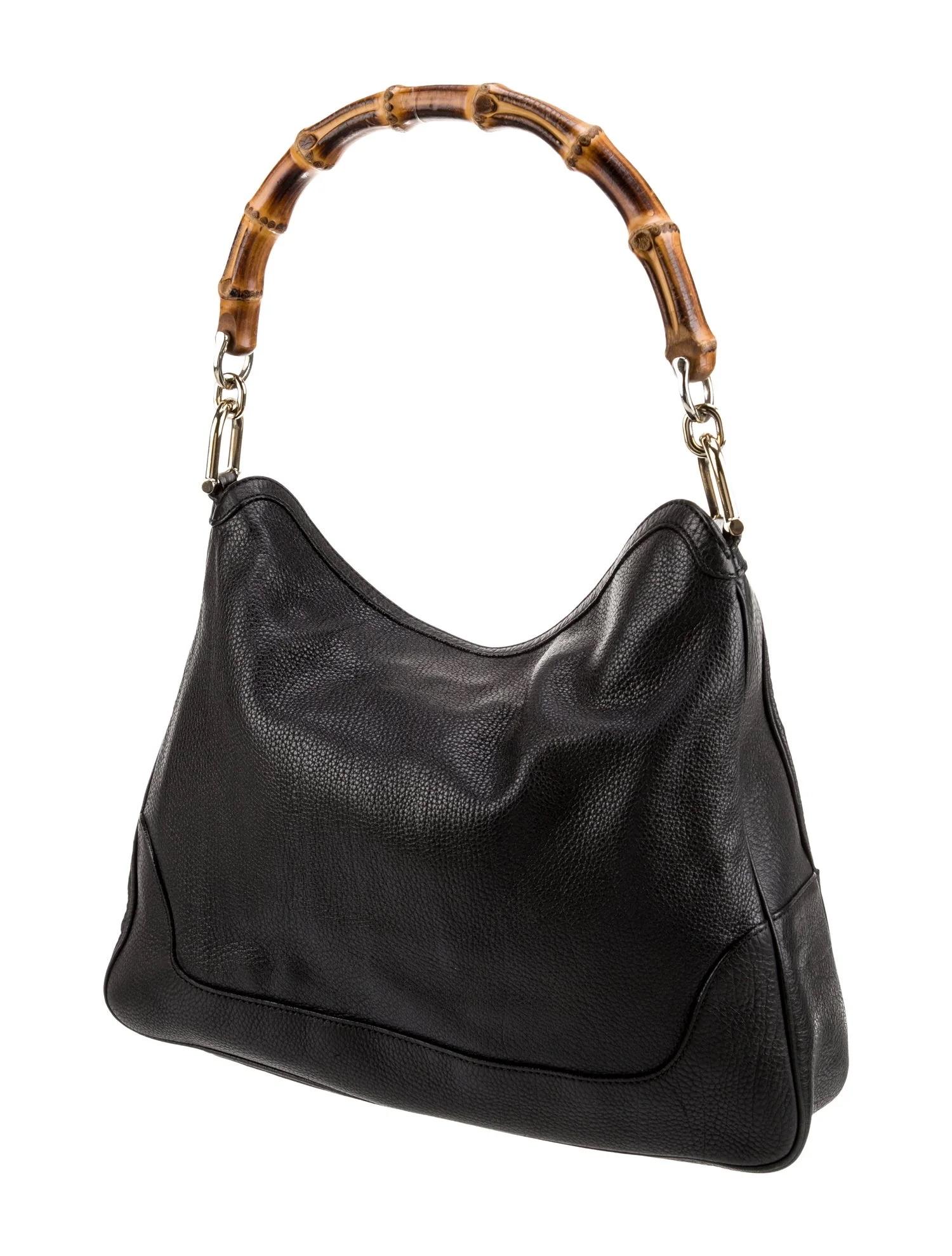 GUCCI PEBBLED LEATHER BLACK DIANA BAMBOO HOBO BAG MEDIUM

Vintage Gucci bag displaying classic Gucci elements. The bag is made with black pebbled leather and features a looping bamboo top handle, gold tone hardware, a slouchy shape and a top snap