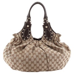 Gucci - Sac à bandoulière Pelham clouté GG Canvas Medium