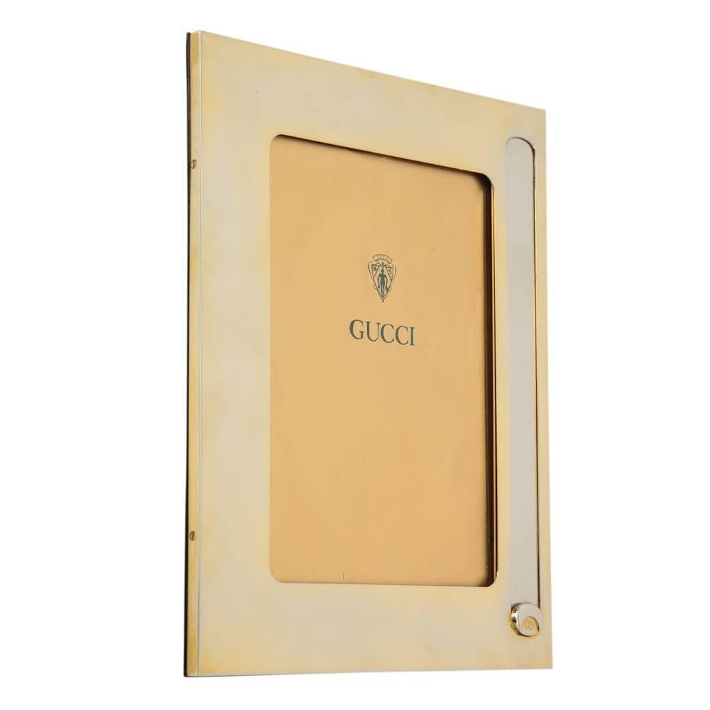 Gucci picture frame, brass and silver plate, signed. Medium scale frame with a nice warm natural patina to the silver plated brass. Polished walnut and rosewood wood backing. The interior photo opening is 5