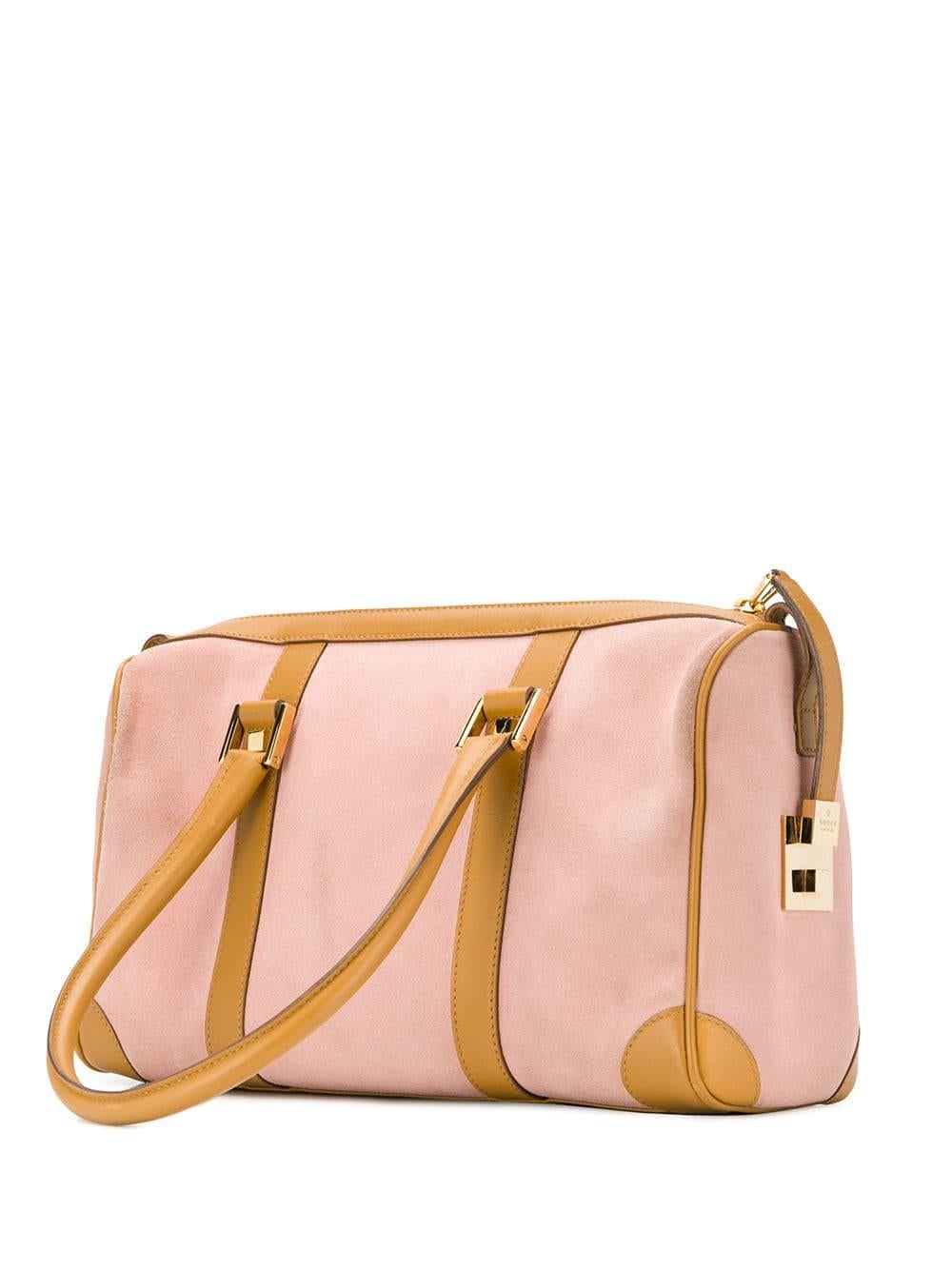 Gucci pink and brown leather and suede two-tone duffle bag featuring a front logo plaque, gold-tone hardware, a top zip fastening, top handles and a main internal compartment.
Width 11in (28cm)
Height 6.7in. (17cm)
Depth 3.9in (10cm)
In good vintage
