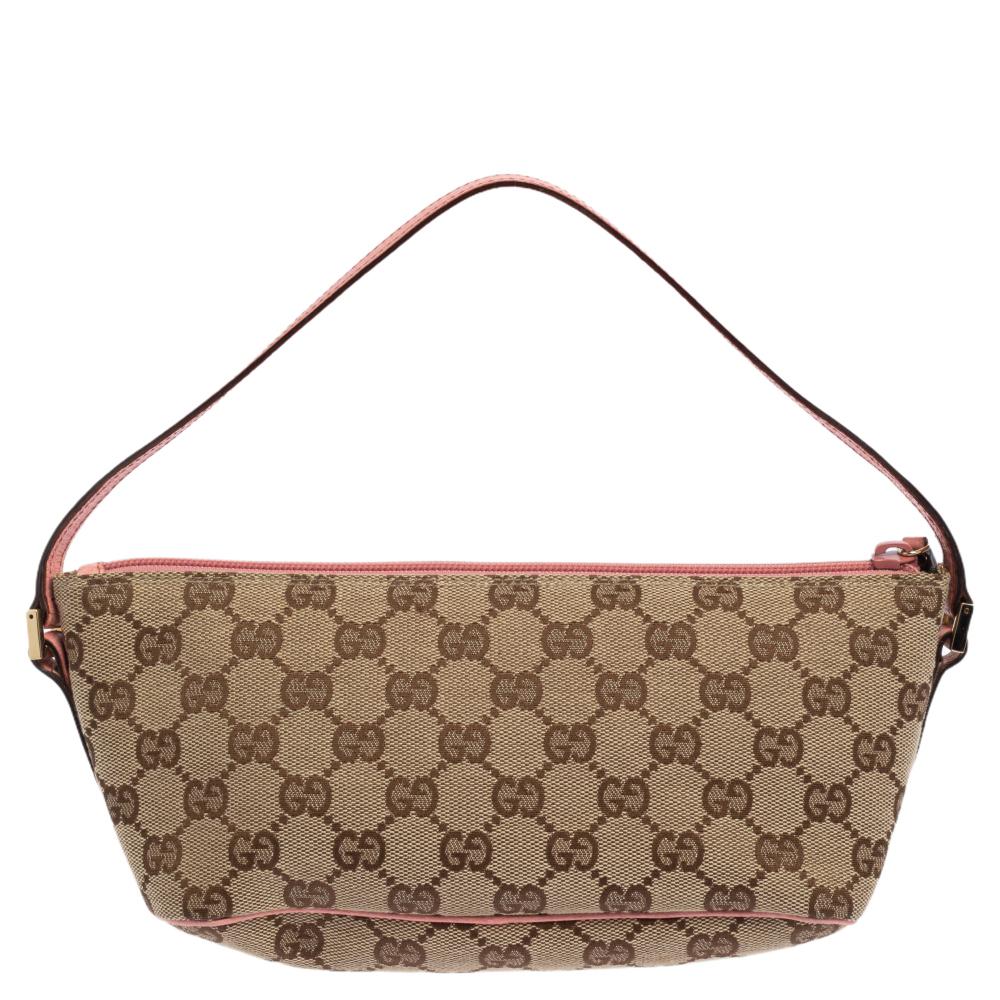 This handy Pochette bag is from the house of Gucci. It has been crafted in Italy and made from signature GG canvas and leather. It comes in beige and pink hues. It is equipped with a canvas interior that will house the essentials you cannot do