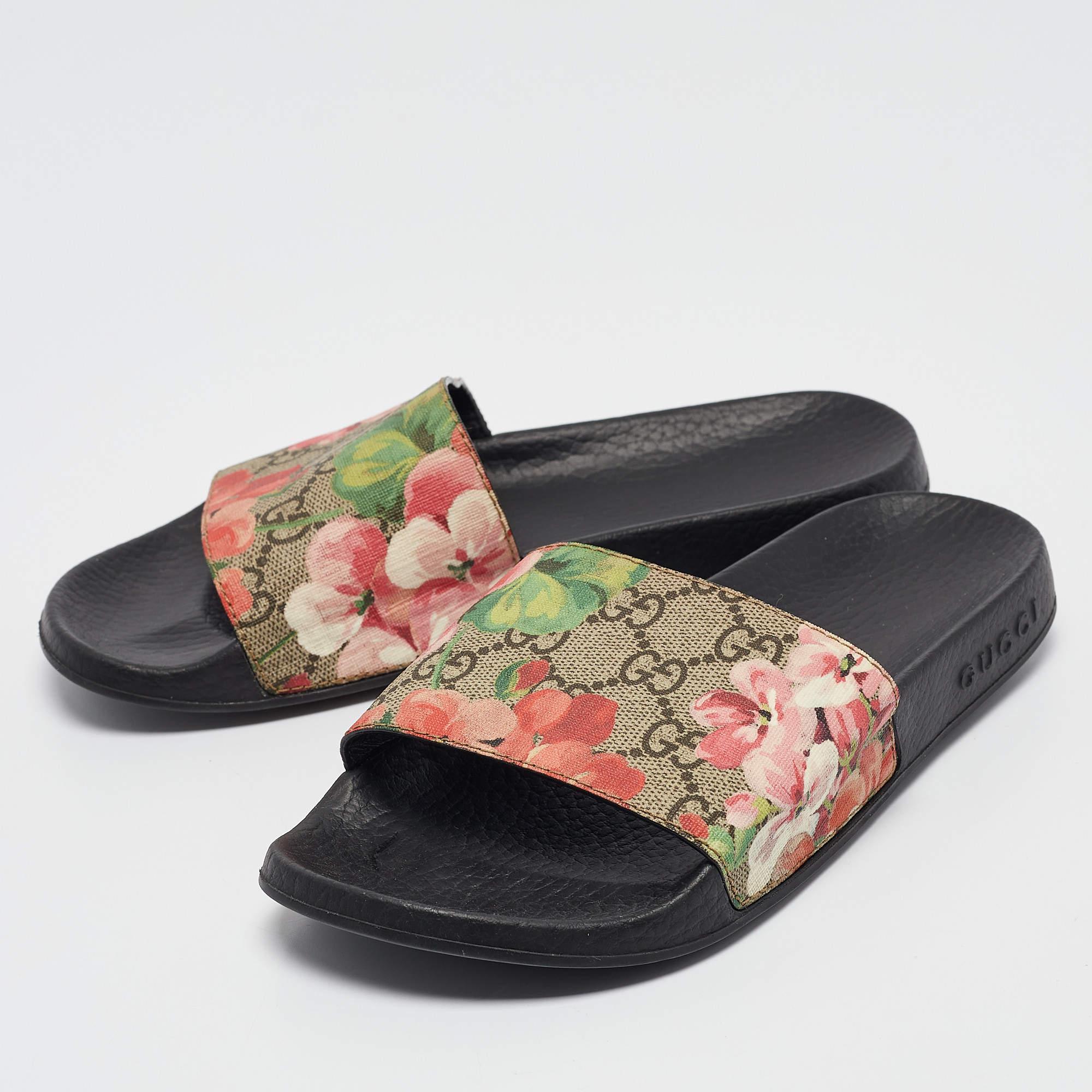 Guccis rubber slides for women have a GG Bloom Supreme canvas panel on the uppers. Theyre perfect for the beach vacation days or everyday use.