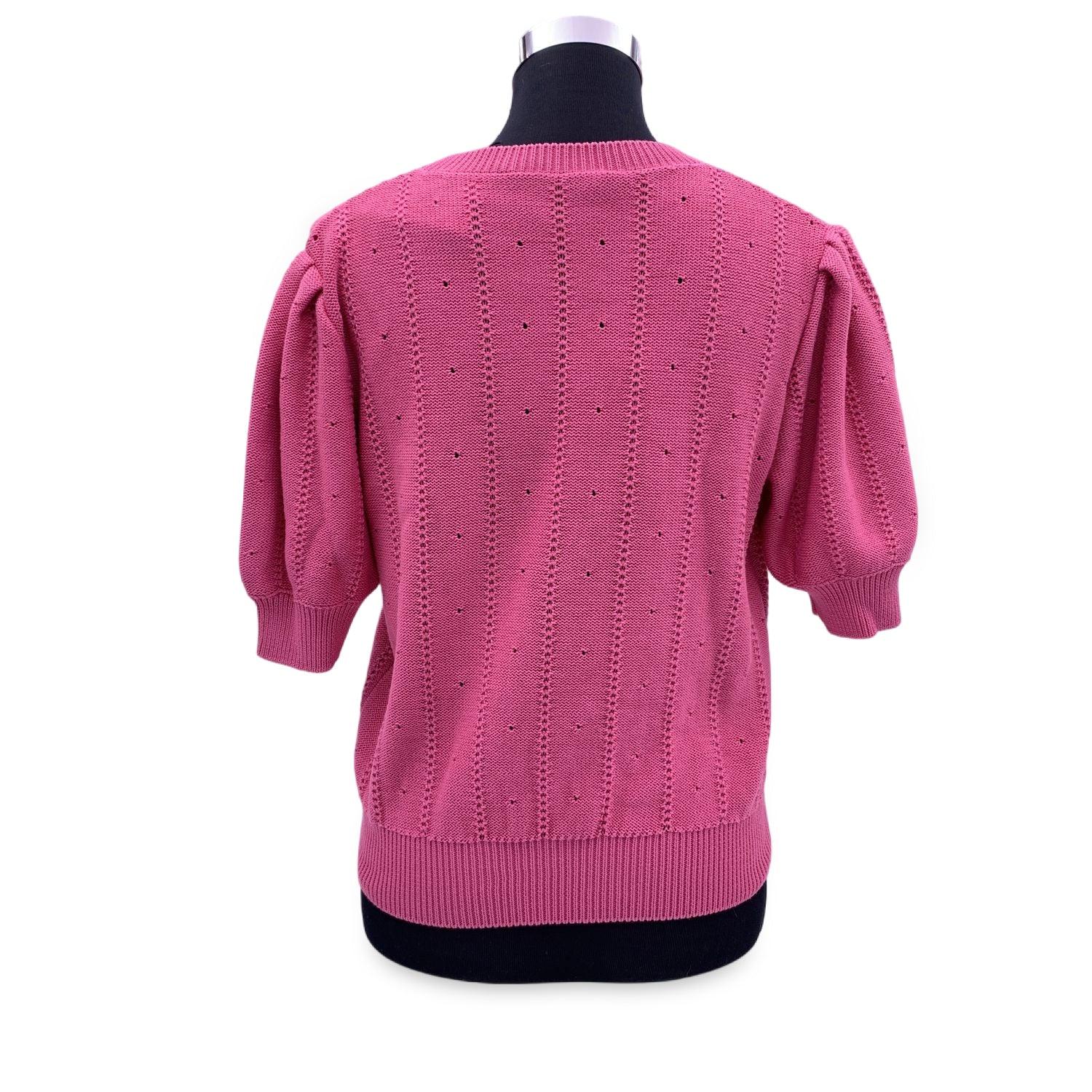Gucci pink cotton-blend short sleeve sweater. It features pointelle pattern, floral embroidery, crewneck, ribbed collar, cuffs and bottom. Composition: 80% Cotton, 20% Silk. Made in Italy. Size XL. Made in Italy. Retail price is EUR 980 Details