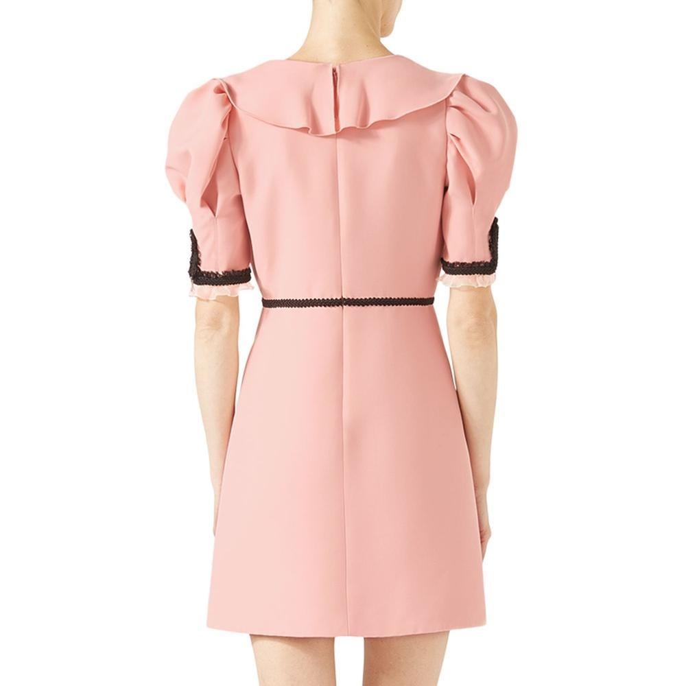 This beautiful A-line dress by Gucci is cut from a fine twill silk-wool blend.
Puff sleeves are decorated with ornately braided embroidery and organza ruffled cuffs, while short zips add a modern touch.
The plunging V-neckline is decorated with a