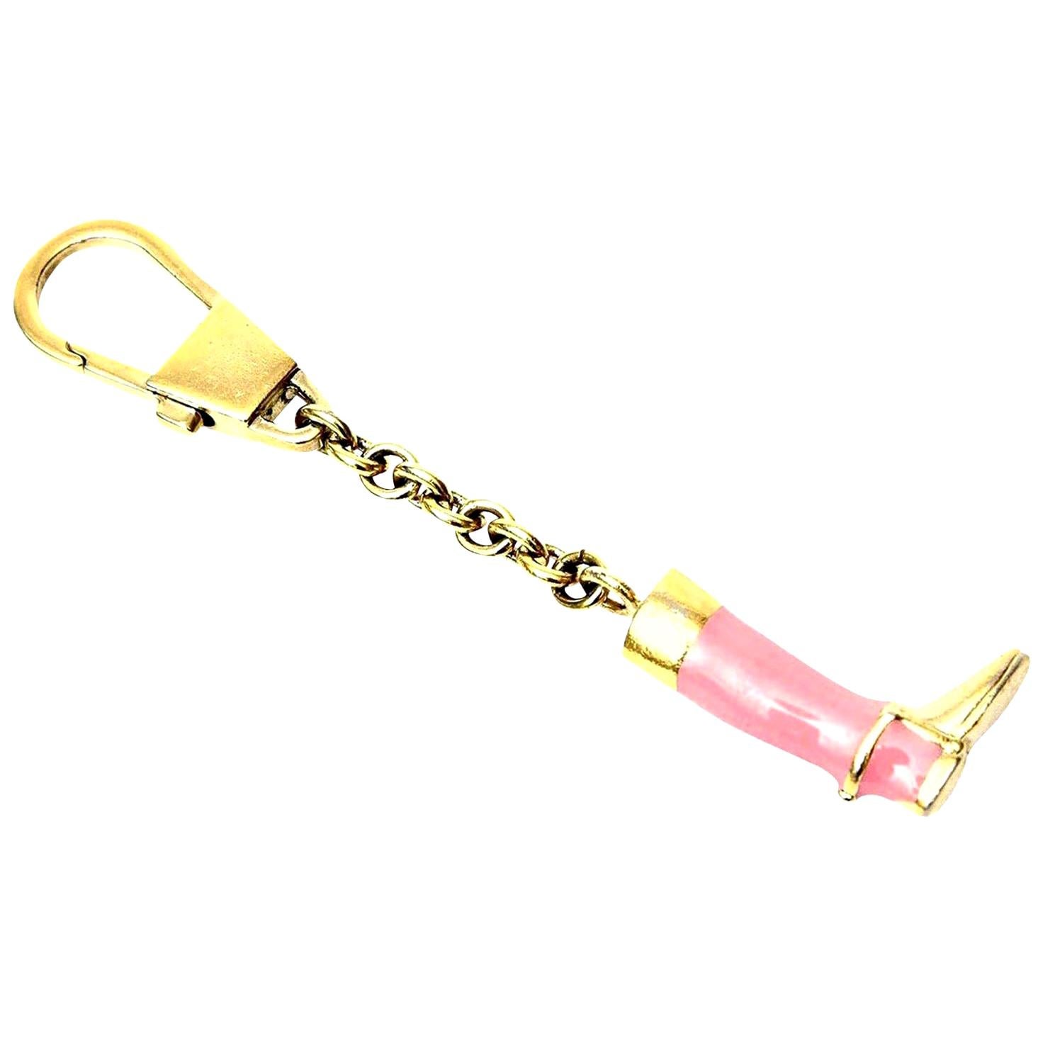 This wonderful Italian vintage signed Gucci stirrup boot key chain has vibrant pink enamel over brass plate. What a chic way to go for your keys. It has good weight to it and is a great keychain. It is from the 70's. These are not common to find