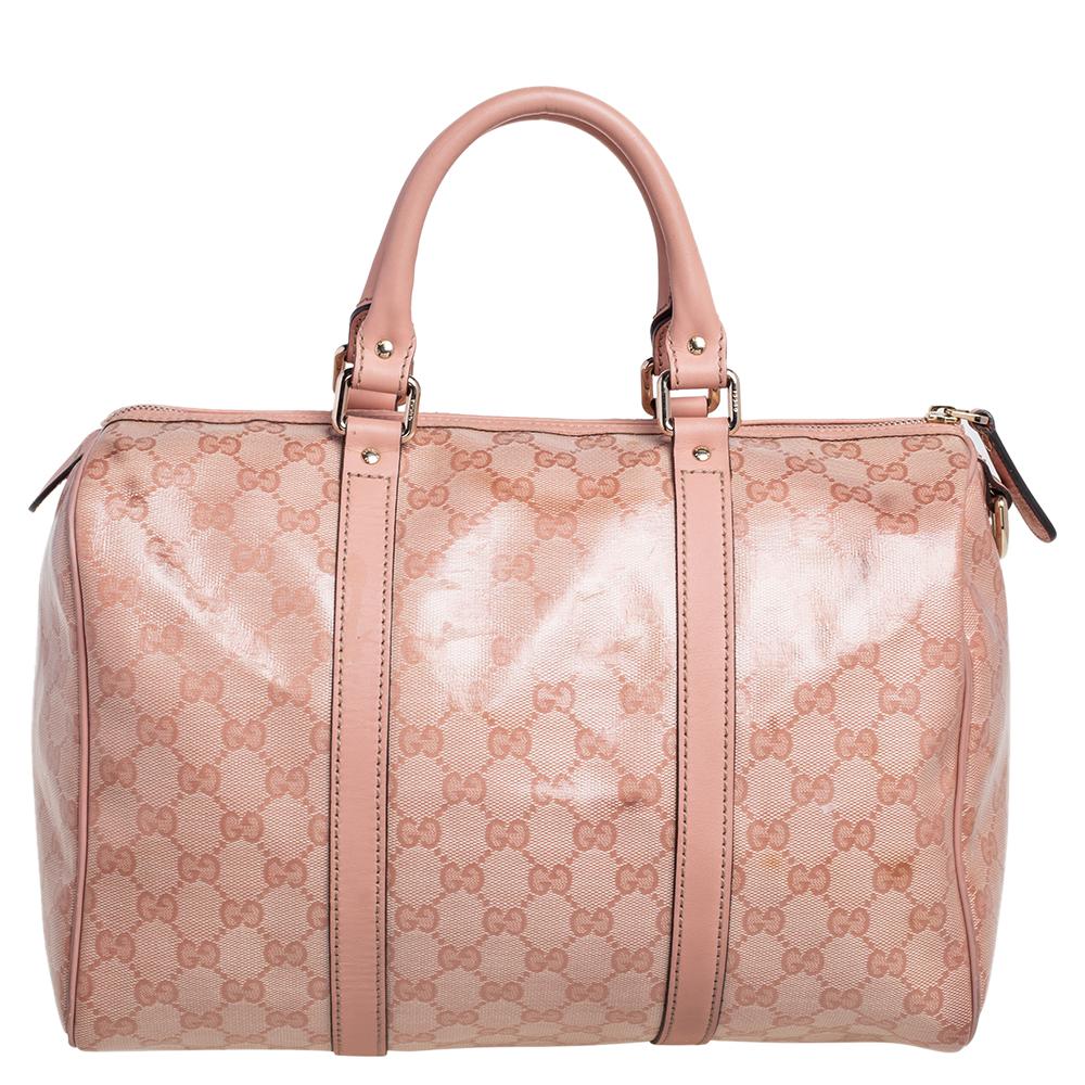 This trendy Joy Boston bag by Gucci is a buy you won't regret. Crafted from GG crystal canvas and styled with leather trims, the bag has a well-sized canvas interior and two top handles for you to easily swing. The piece is complete with the brand