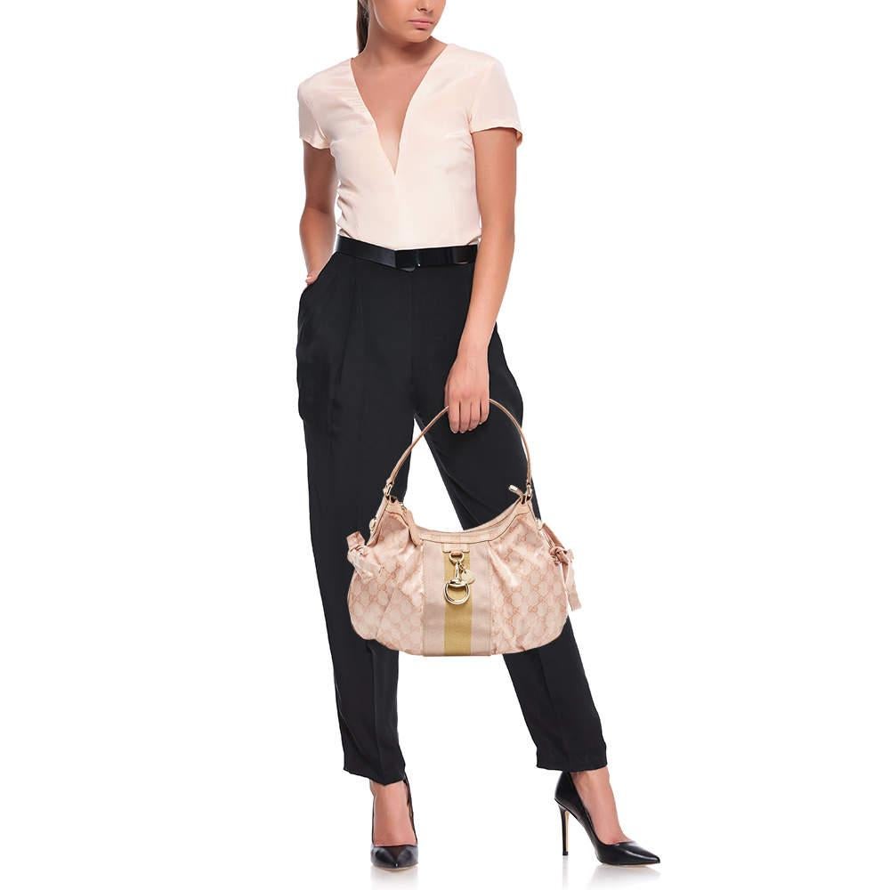 Owning a Gucci bag is every fashionista's dream. This Gucci hobo is one you don’t want to miss out on. The exterior is made from crystal GG canvas and accented with gold-tone hardware, Gucci round plaque and signature horsebit. This hobo features a