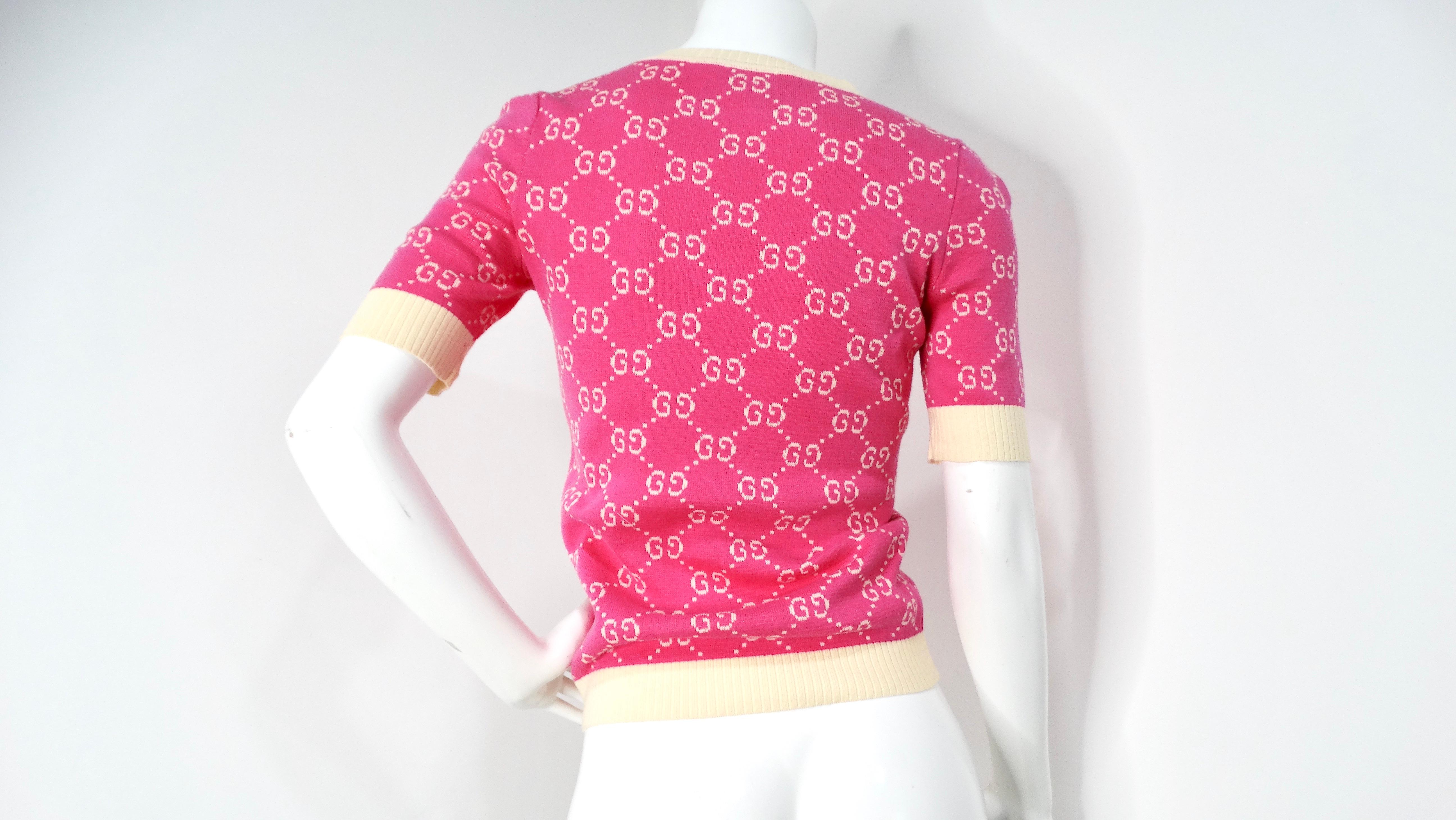 The Gucci Pink GG Monogram Logo Cotton Knit Top is an exquisite piece that exemplifies luxury and contemporary fashion. Crafted from premium cotton, this top boasts the iconic GG monogram in a soft, playful pink hue, adding a feminine touch to a