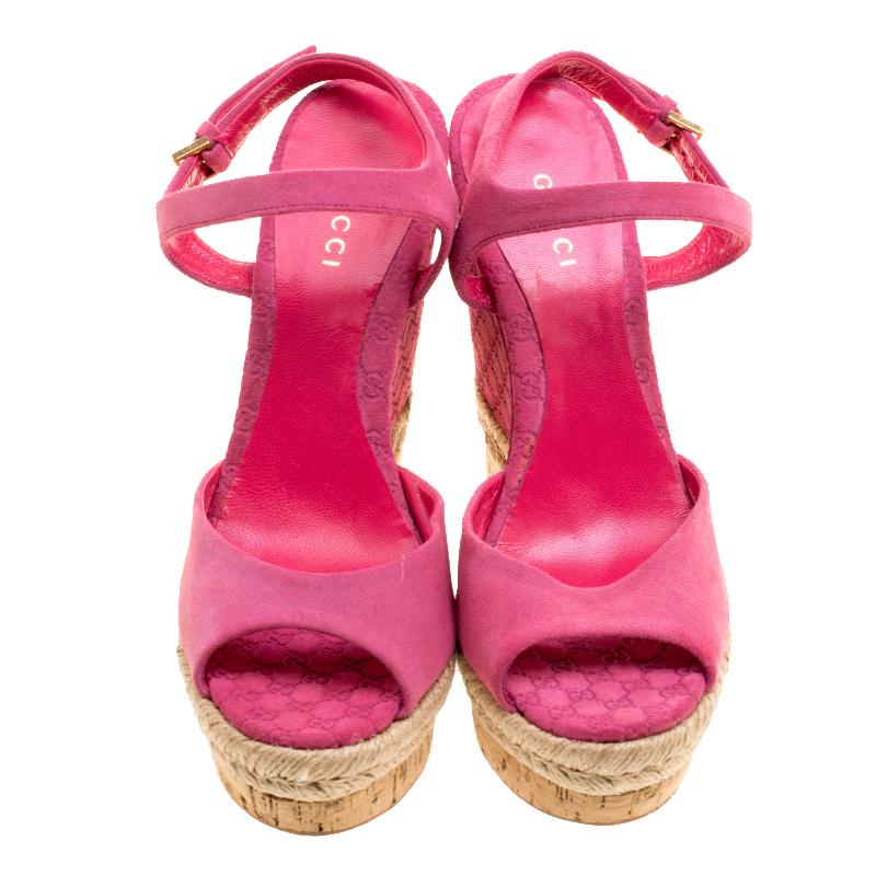 These sandals from Gucci are bearers of a fine mix of shoe craftsmanship and style. The leather sandals carry a superb design of front straps, ankle fastenings and Guccissima wedges beautified with espadrille detailing and cork inserts. The pink