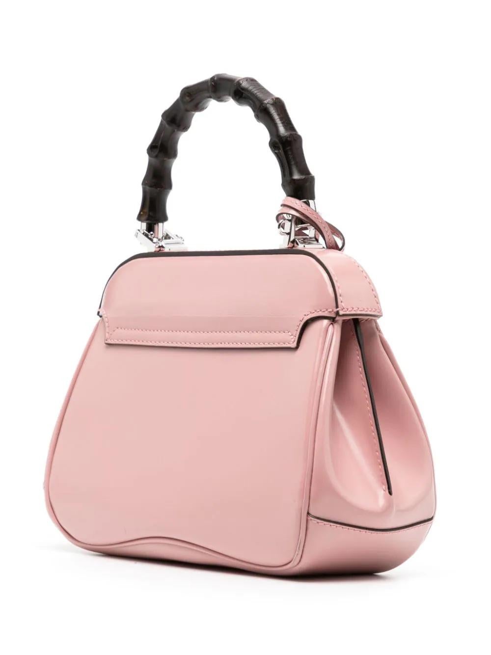 * Pink
* Leather
* Signature bamboo top handle
* Detachable shoulder strap
* Foldover top
* Push-lock fastening
* Main compartment
* Internal slip pocket
* Leather tag
* Silver-tone hardware
* Very Good Condition: This pre-loved item is in very good