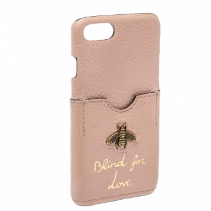 Opt for a stylish way to protect your phone with this Gucci cover crafted from leather in a pink hue. It flaunts a card slot adorned with the label's signature bee motif and 'BLIND FOR LOVE' lettering. The creation is suitable for iPhone 7.