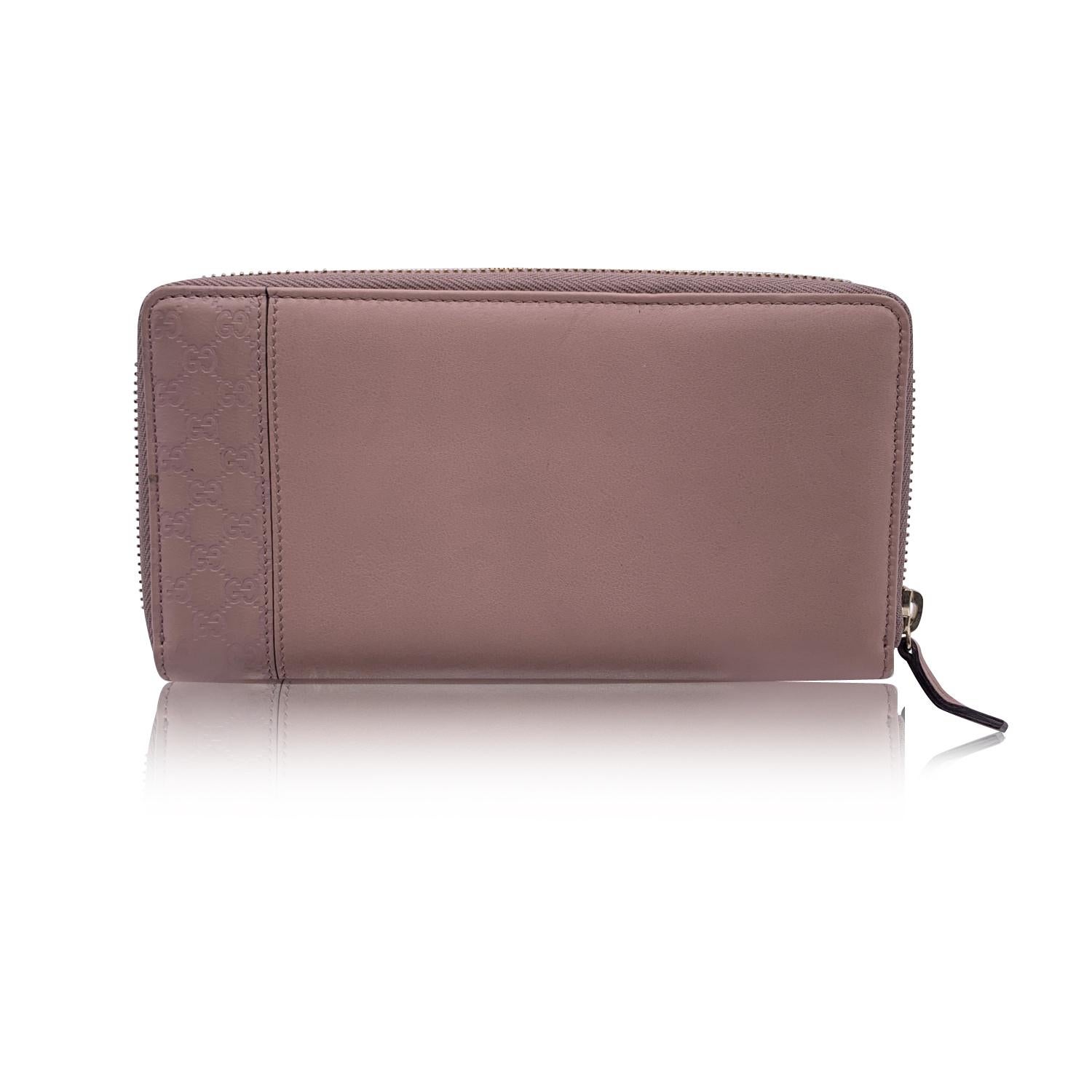 Beautiful Gucci continental wallet, crafted in pink leather. Microguccissima trim on the side. Zip around closure. Leather interior. 3 main sections for bills, 1 zip compartment, 12 credit card slots and 1 flat open pocket inside. 'Gucci - Made in