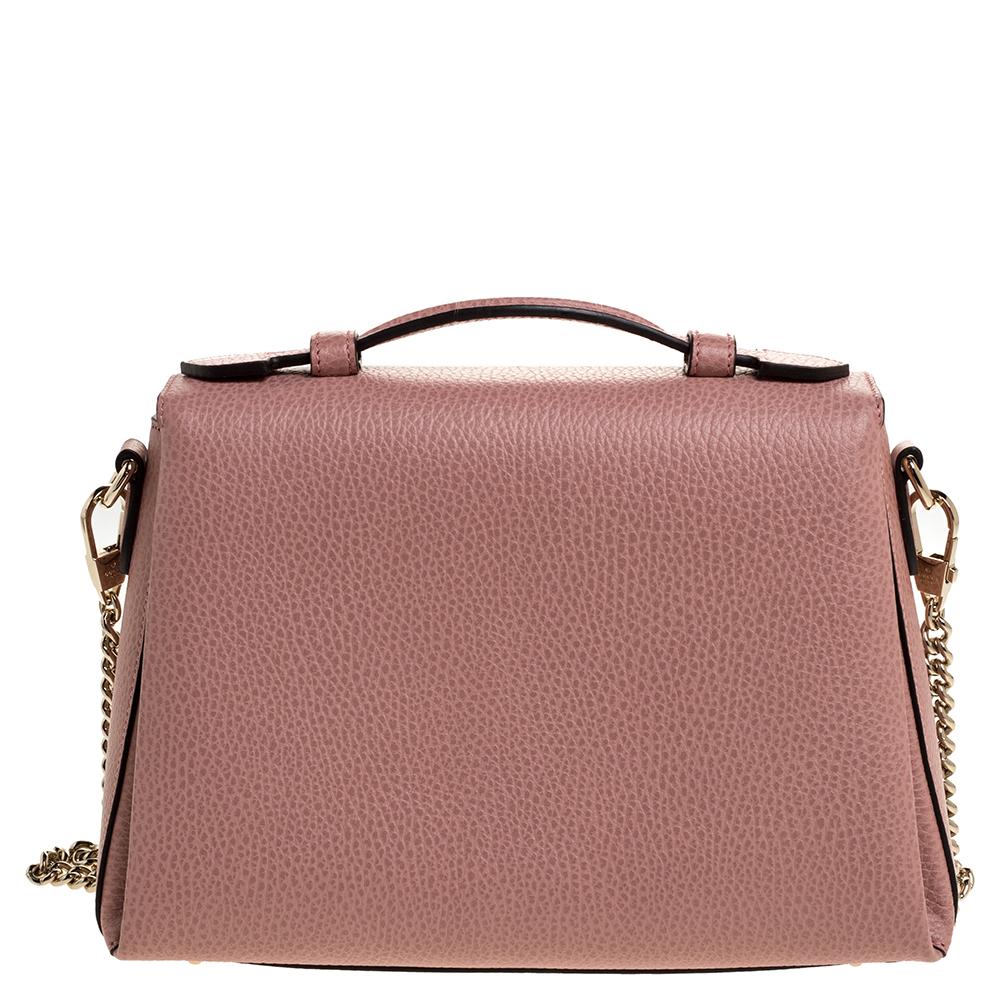 Crafted in leather, this impressive bag by Gucci is an amazing creation to own. It comes in pink color and has a neat fabric-lined interior that can house your essentials. It features a top handle & a shoulder strap that you can use to swing it