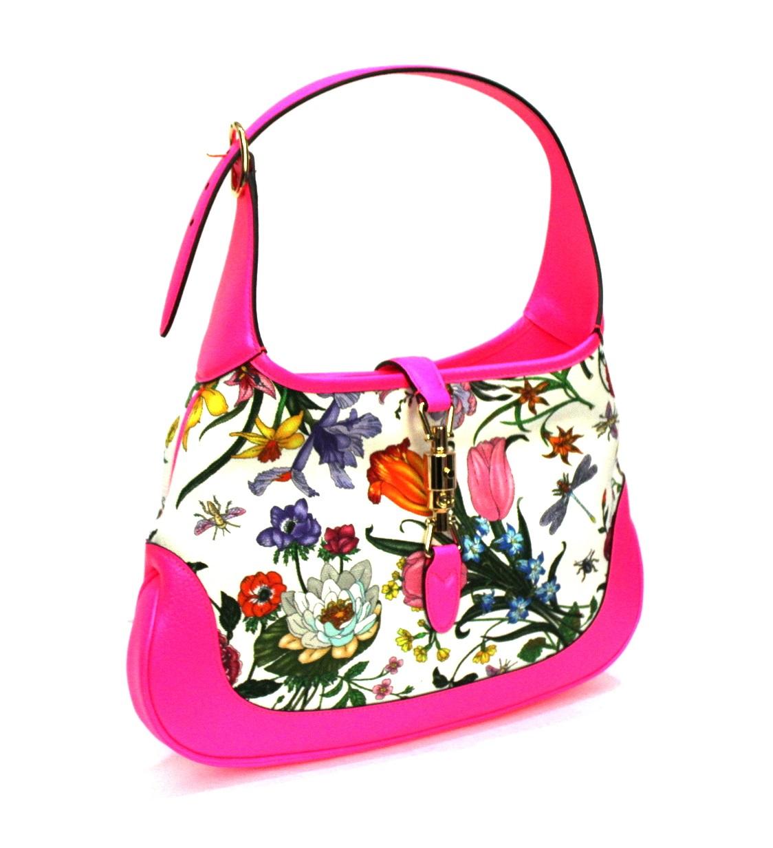 Gucci bag model Jackie Flora line made of canvas with floral pattern and fluo pink leather. Closure with golden hook, internally quite large. Equipped with top handle to wear it comfortably on the shoulder. Conditions like new