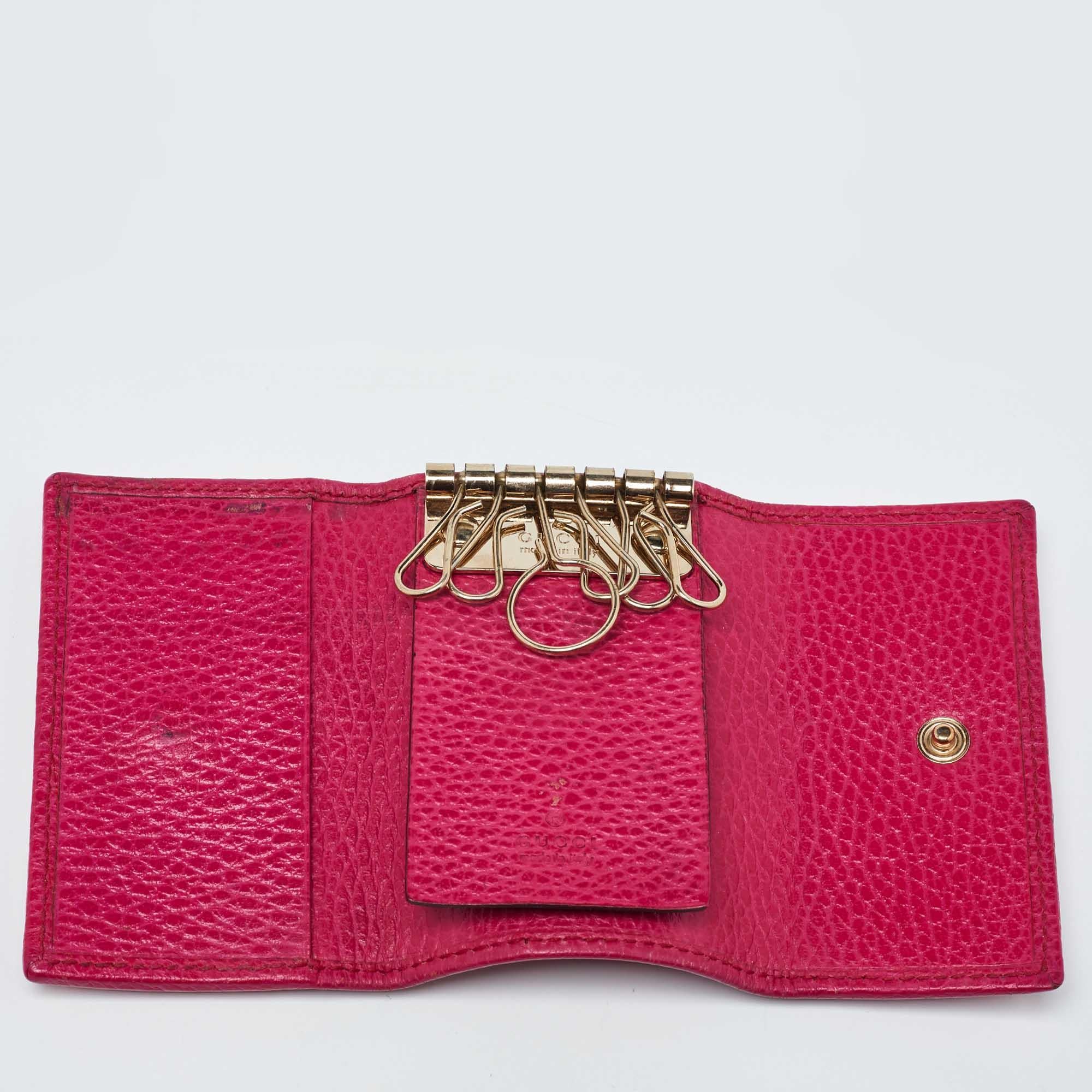 Now you can secure all your keys in this handy yet exquisite case from Gucci. Made from pink leather the purse has a gold tone accents and opens to reveal a leather compartment. This creation is stylish and sleek.