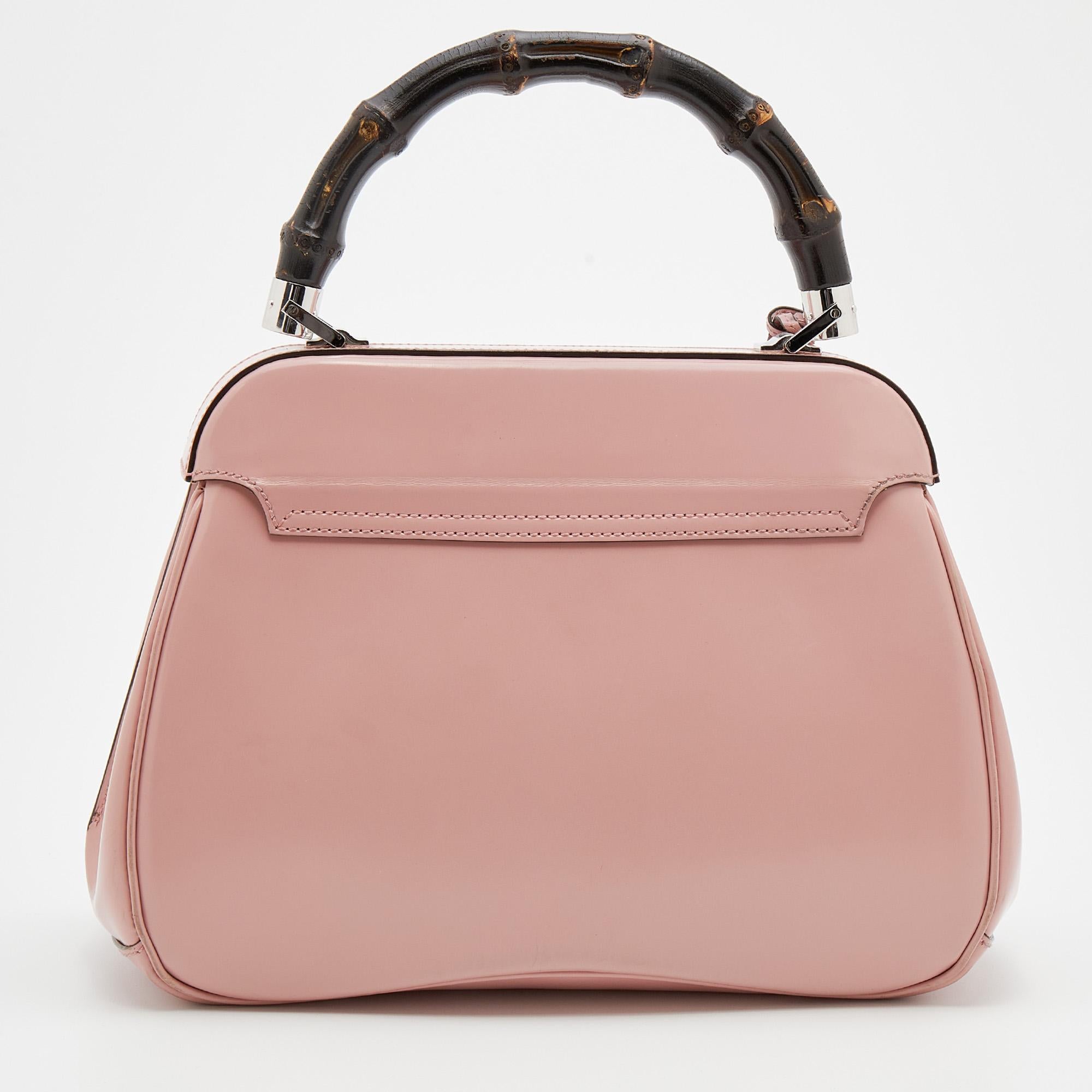 Crafted from pink leather, this fabulous Gucci bag has a front flap that is detailed with the signature Lady Lock and opens to a roomy interior. It also flaunts a single bamboo top handle. Make it your own today!

Includes: Original Dustbag, Keys,