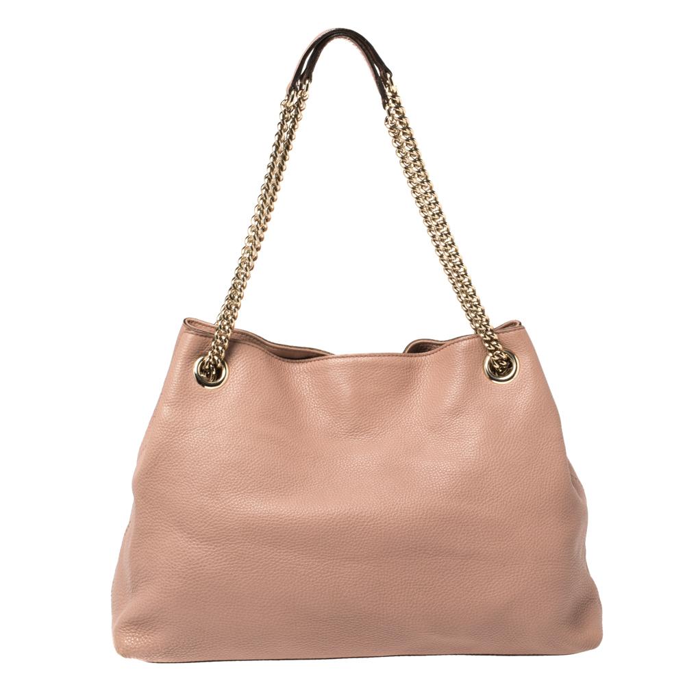 The Soho tote has captured the hearts of women around the globe! This bag is constructed from pink leather and designed with the signature GG logo on the front. It comes endowed with a spacious canvas interior for your essentials, two chain handles