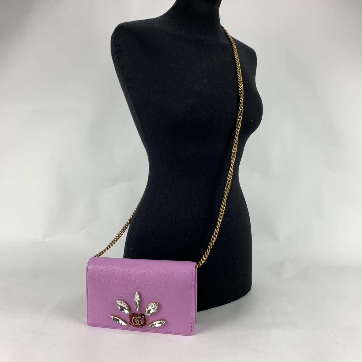 Beautiful Gucci Mini Double G Wallet on Chain in pink leather embellished with crystals. The bag features a flap with button closure, built-in mirror on the reverse of the flap and 1 slit pocket under the flap. Black nylon lining. 1 side zip pocket,